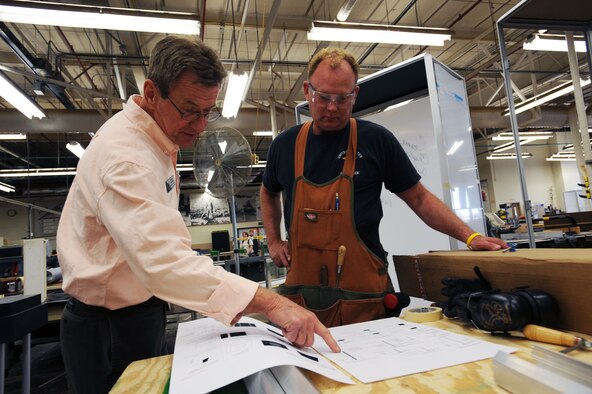 DAYTON, Ohio (04/2010) -- In preparation for the 60th anniversary of the Korean War, the National Museum of the U.S. Air Force is renovating its Korean War exhibit. Here, exhibits specialists look over plans for the gallery. (U.S. Air Force photo/Master Sgt. William Greer)