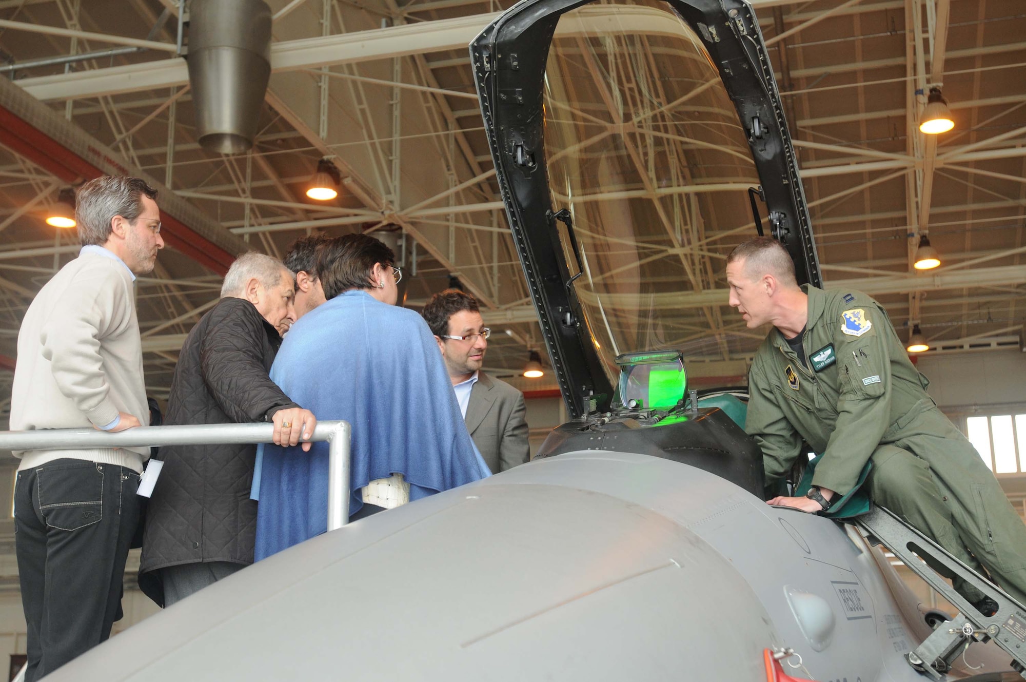 Capt. Tyler Niebuhr, 555th Fighter Squadron executive officer, explains the cockpit functions of an F-16 Fighting Falcon May 13 to off-base doctors affiliated with Tricare. More than 50 off-base doctors were invited to visit Aviano as a show of appreciation for their hard work. (U.S. Air Force photo/Airman LaVel Sterling)
