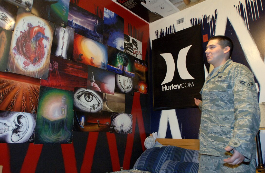 LANGLEY AIR FORCE BASE, Va. -- Airman 1st Class Adam Torres, 633d Civil Engineer Squadron electrical power production technician, explains the personalization of his dorm room May 13. Torres won the Room of the Quarter award, which afforded him a three-day pass. (U.S. Air Force photo/Airman 1st Class Jason J. Brown)