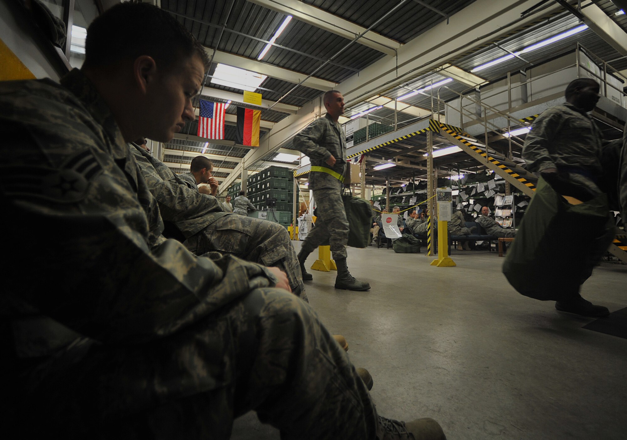 U.S. Air Force Senior Airman Mike McJohn (left), 1st Combat Communications Squadron, waits to receive new chemical protective gear at the 86th Logistics Readiness Squadron’s individual protective equipment facility, Ramstein Air Base, Germany, May 17, 2010. Many Airmen have visited the facility to exchange their outdated gear in preparation for the upcoming Operational Readiness Inspection. (U.S. Air Force photo by Senior Airman Tony R. Ritter)