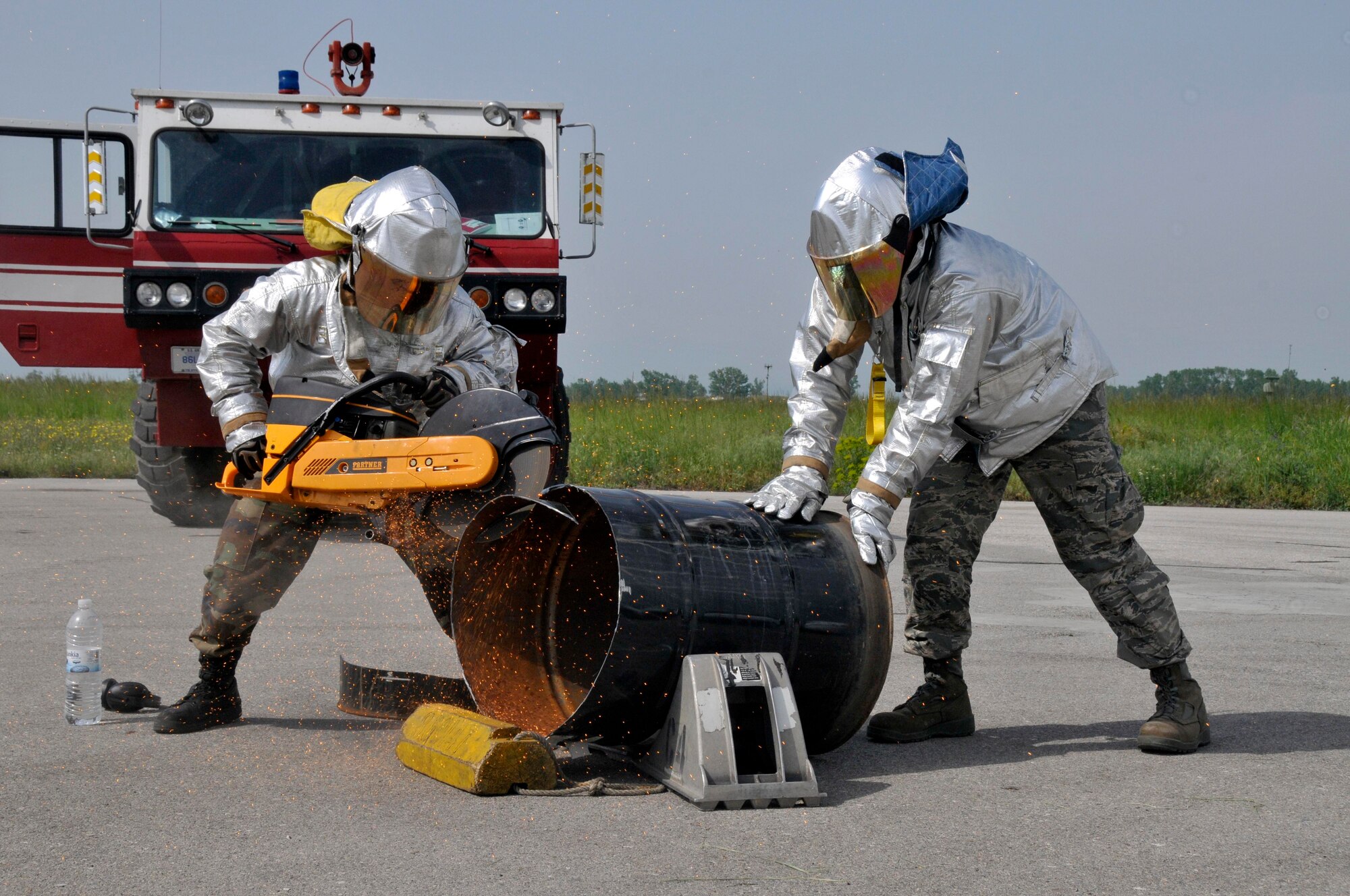 GRAF IGNATIEVO AIR FORCE BASE, Bulgaria - Airmen 1st Class Phil Crews and Jared Williams, 48th Civil Engineer Squadron firefighters, make a burn barrel at Graf Ignatievo Air Force Base, Bulgaria, May 13, for the destruction of classified material. Making the burn barrel allows the firefighters to maintain proficiency on the K-12 rescue saw. The Airmen are in Bulgaria as part of Sentry Gold, a joint U.S. and Bulgarian exercise.