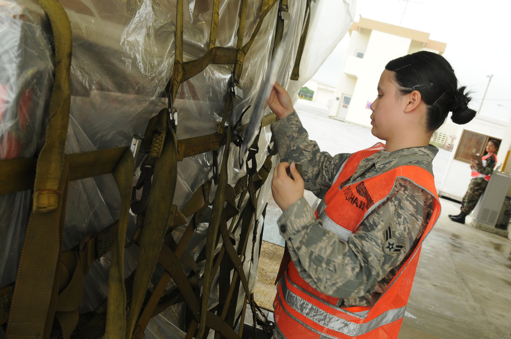 Airman 1st Class Michelle Rives, 18th Logistics Readiness Squadron, performs
a cargo in-check on an equipment pallet before flight May 17, Kadena Air
Base, Japan. (U.S. Air Force photo/Staff Sgt. Christopher Hummel)
