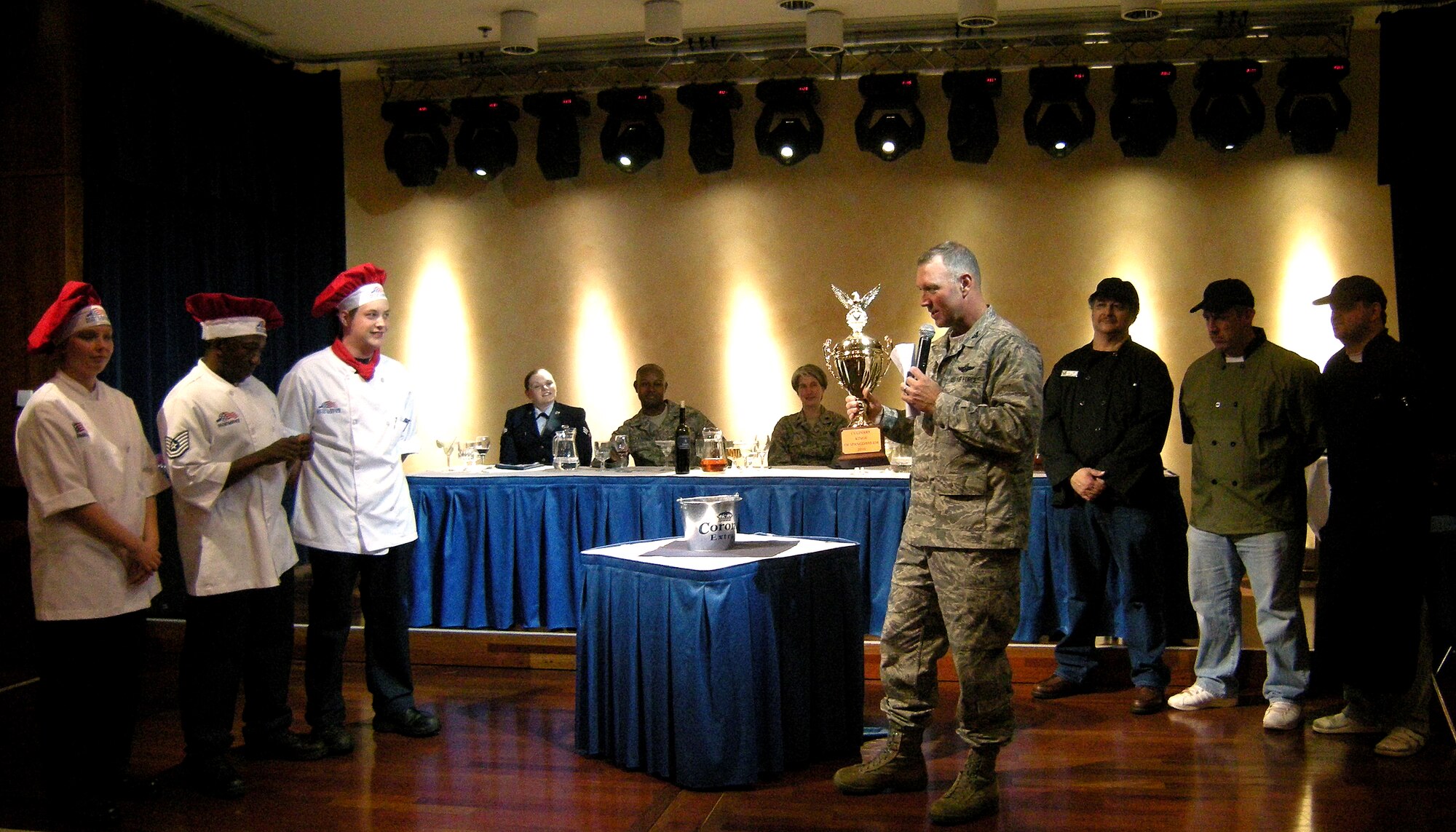 SPANGDAHLEM AIR BASE, Germany – Col. Tip Wight, 52nd Fighter Wing commander, talks to the participants in the first-ever Ultimate Chef Showdown  before announcing the winner at Club Eifel May 13. Participants included chefs from the dining facility (left) and Club Eifel. The judges deemed the dining facility’s appetizer and dessert to be the tastiest of the two, while Club Eifel received kudos for its main course. The overall winner was Club Eifel. (U.S. Air Force photo/2nd Lt. Kathleen Polesnak)