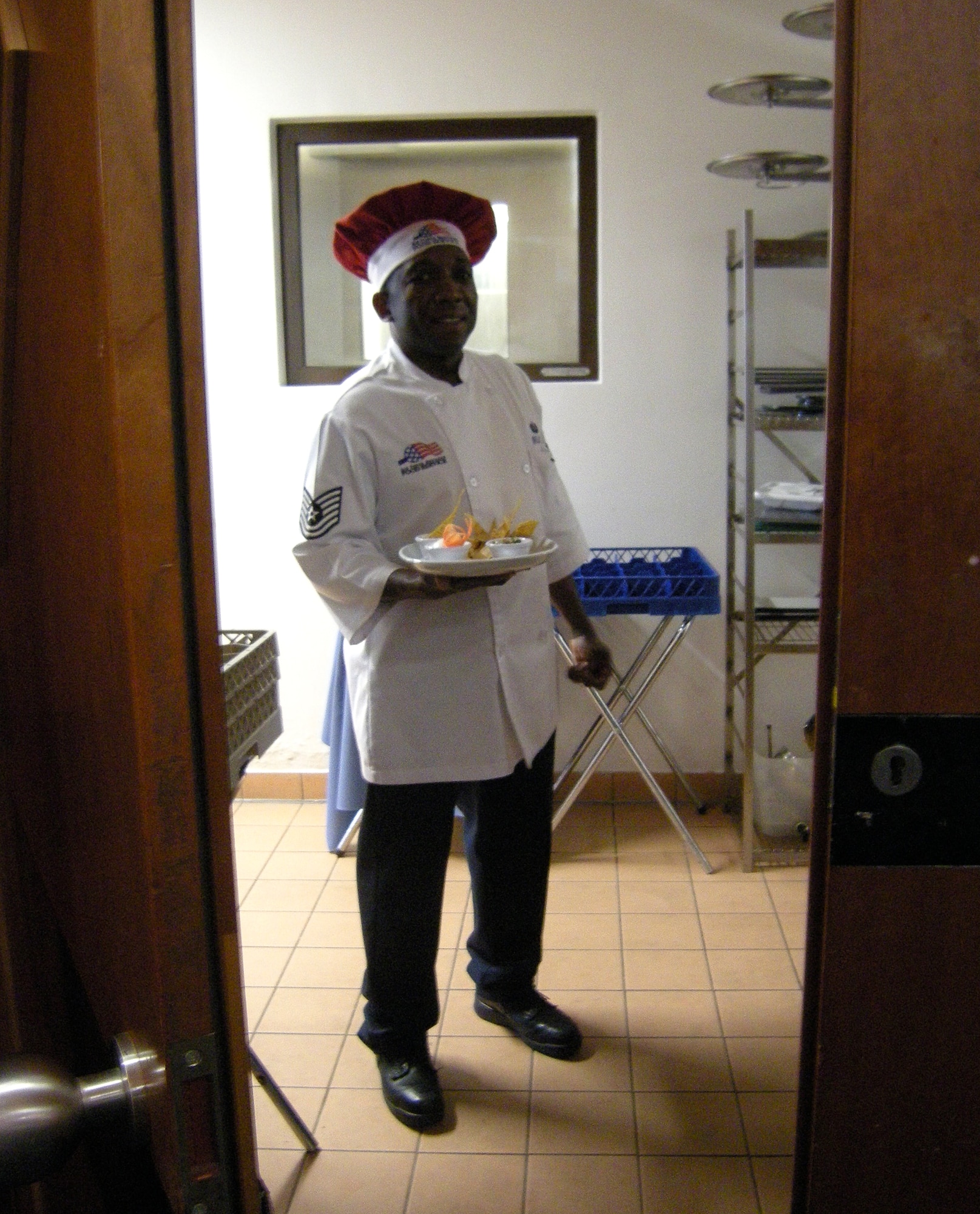 SPANGDAHLEM AIR BASE, Germany – Tech. Sgt. Jermaine Ireland, 52nd Force Support Squadron food service craftsman, stands ready to deliver the dining facility team’s first course to the judges during the Ultimate Chef Showdown at Club Eifel May 13. Sergeant Ireland was the head chef for the dining facility during the contest, which was the first of its kind between the DFAC and Club Eifel. The overall winner was Club Eifel, while the dining facility was commended for having the best appetizer and dessert.  (U.S. Air Force photo/2nd Lt. Kathleen Polesnak)