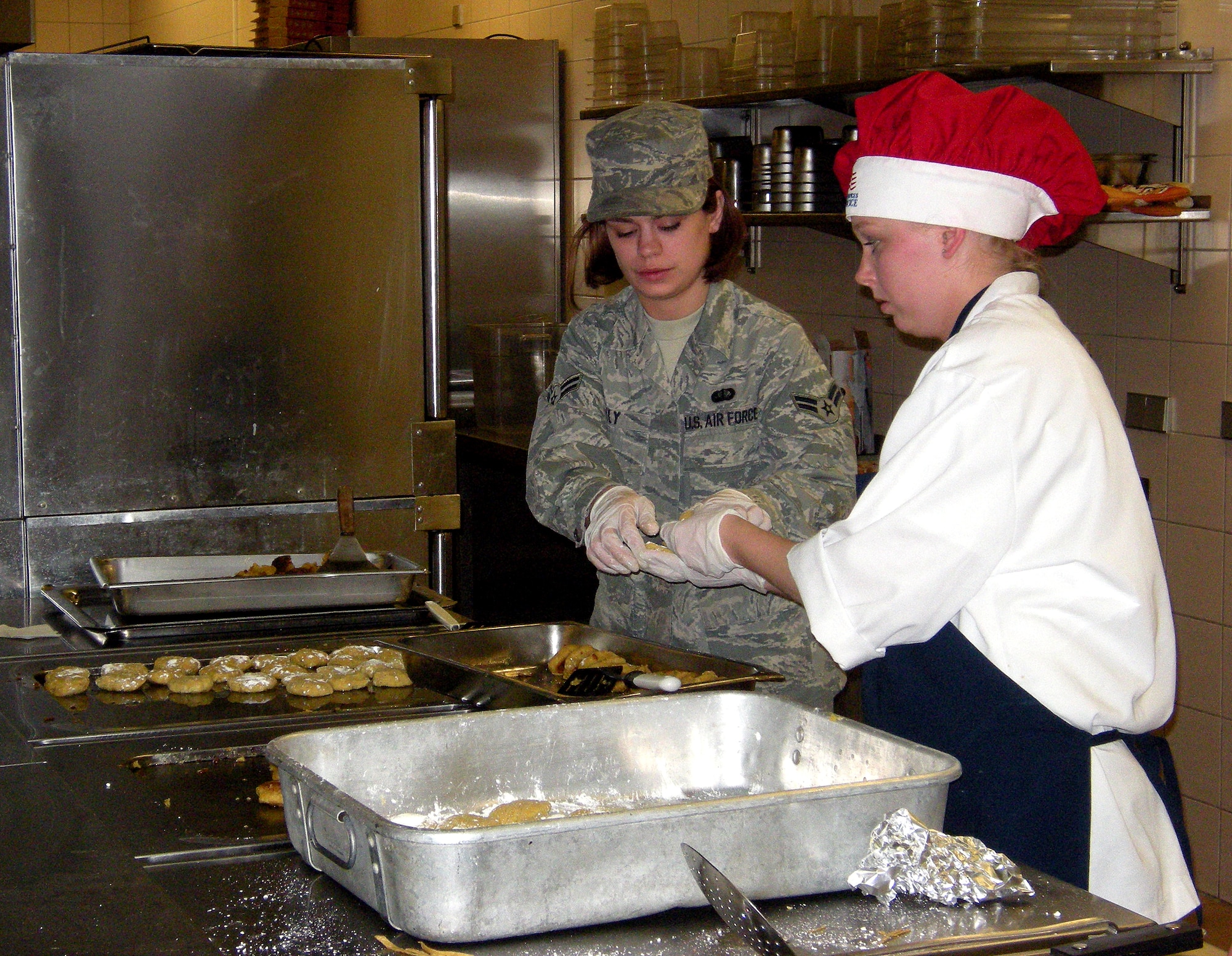 SPANGDAHLEM AIR BASE, Germany – Airman 1st Class Kimberly Lilly (left) and Senior Airman Brandi Slosser, both 52nd Force Support Squadron food service apprentices, prepare food in the Club Eifel kitchen for the dining facility’s three-course Mexican dinner during the Ultimate Chef Showdown May 13. This was the first chef competition held here between the base’s two largest food service agencies – the dining facility and Club Eifel. The overall winner was Club Eifel, while the dining facility was commended for having the best appetizer and dessert.   (U.S. Air Force photo/2nd Lt. Kathleen Polesnak)