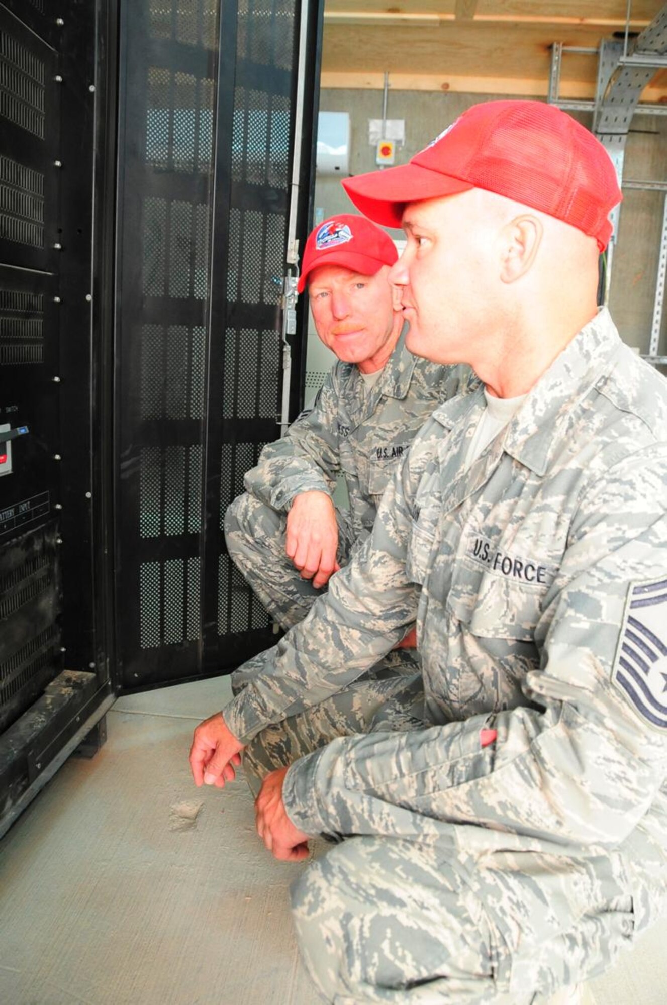 Chief Master Sgt. Richard Bressler (L), Chief Enlisted Manager, and Senior Master Sgt. Craig Boston, Site Supervisor, 557th Expeditionary RED HORSE Squadron, inspect power control panels for the Ali Base airfield lighting system May 14, 2010.  Both Airmen are deployed from the 200th RHS, Camp Perry, Ohio ANG Base.  (U.S. Air Force photo by Master Sgt. Darrell Habisch/released)
