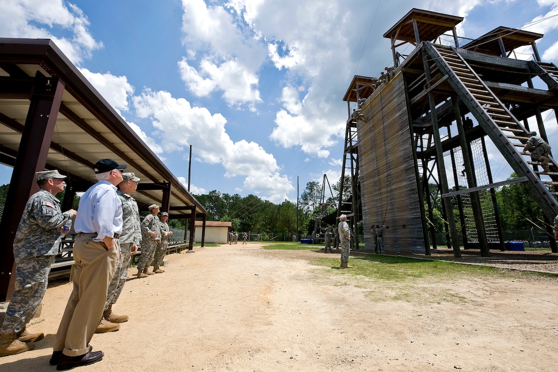 Defense Secretary Robert M. Gates watches Army basic trainees as they go through rope training at Eagle Tower on Fort Benning, Ga., May 15, 2010.