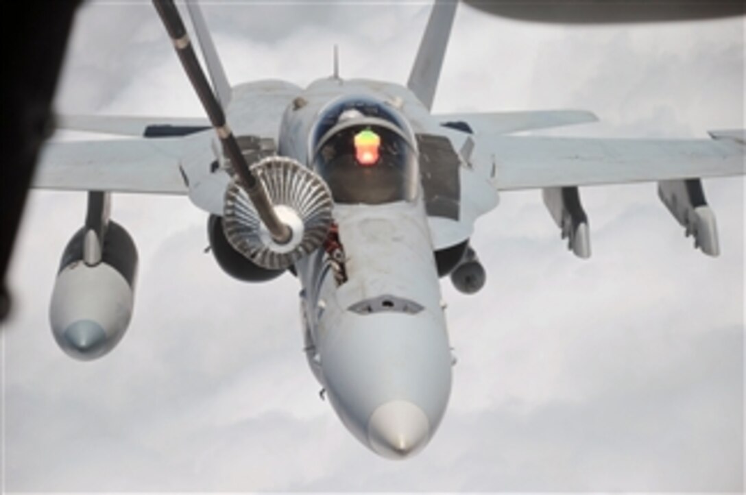 A U.S. Navy F/A-18 Hornet aircraft is refueled by an Air Force KC-10 Extender aircraft from the 908th Expeditionary Air Refueling Squadron during a mission at a base in Southwest Asia on April 24, 2010.  The 908th Expeditionary Air Refueling Squadron, as part of the 380th Air Expeditionary Wing, supports operations Iraqi and Enduring Freedom and Combined Joint Task Force-Horn of Africa.  