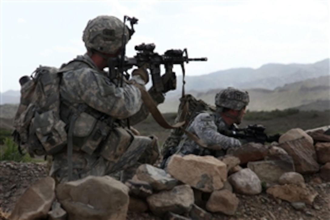 U.S. Army Sgt. Maj. Mark Bartosch, right, and Staff Sgt. Bradley Watts pull security on the outskirts of the village of Margah, on a presence patrol, Paktika province, Afghanistan, May 6, 2010. Bartosch and Watts are assigned to Company ABU, 1-187th Infantry, Air Assault, Combat Outpost Margah.