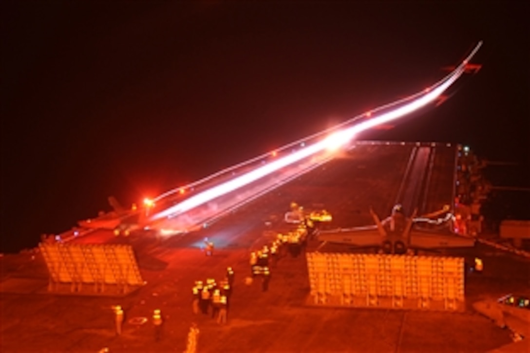 An F/A-18C Hornet launches from the  USS Enterprise during night-flight operations in the Atlantic Ocean, May 13, 2010. The Enterprise is conducting flight-deck certification in preparation for its 21st deployment.