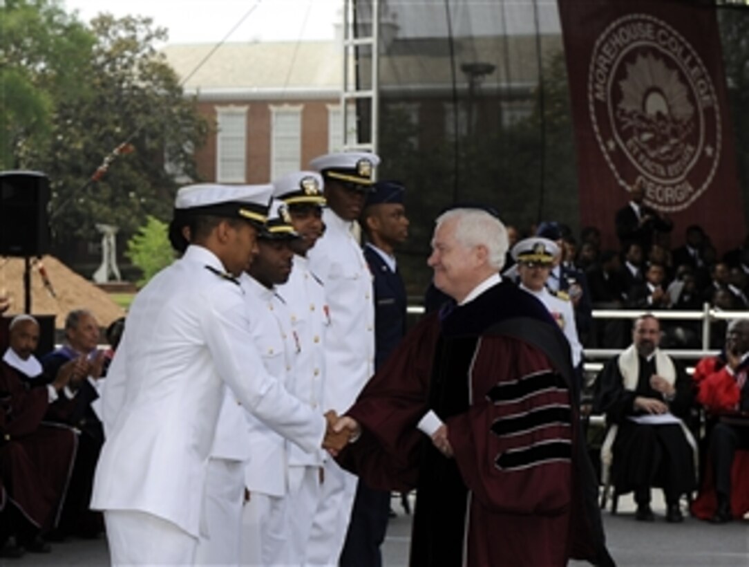 Secretary of Defense Robert M. Gates congratulates newly commissioned sailors and airmen after delivering the Oath of Office to them at Morehouse College's 126th Commencement ceremony in Atlanta, Ga., on May 16, 2010.  