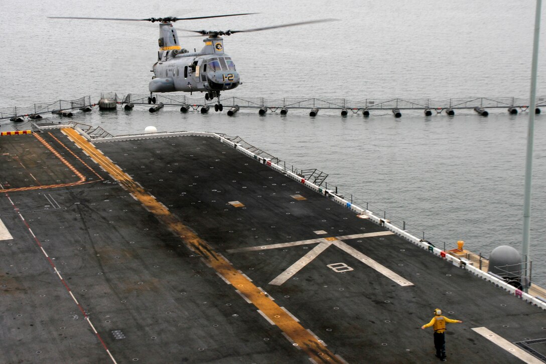 “1-2” a CH-46E Sea Knight flown by Lt. Col. Todd J. Oneto (One-to), commanding officer of Marine Medium Helicopter Squadron 165 (Reinforced), lands on the flight deck of USS Peleliu. Oneto has been flying with CH-46E’s for over 16 years and has been the commanding officer for HMM-165 (REIN) since Jan. 17, 2009.