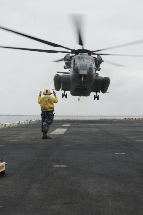 A CH-53E "Super Stallion" with Marine Medium Helicopter Squadron 165 (Reinforced) prepares to land on the USS Peleliu docked at Naval Base San Diego May 17, 2010. HMM-165 (Rein) is preparing to ship out with the 15th Marine Expeditionary Unit on May 20, 2010, to the Western Pacific for a seven-month deployment.