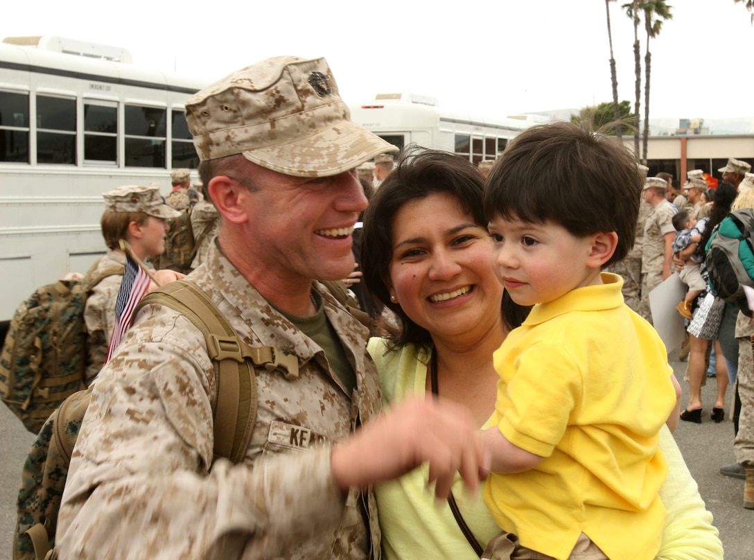 Lt. Cmdr. Michael J. Kerns, 42, Poulsbo, Wash., reunites with his family after returning from a seven -month deployment to Camp Leatherneck, Afghanistan. During the homecoming celebration, more than 200 service members from 7th Engineer Support Battalion, 1st Marine Logisitcs Group reunited with their loved ones at the 22 Area parade deck here, May 17.