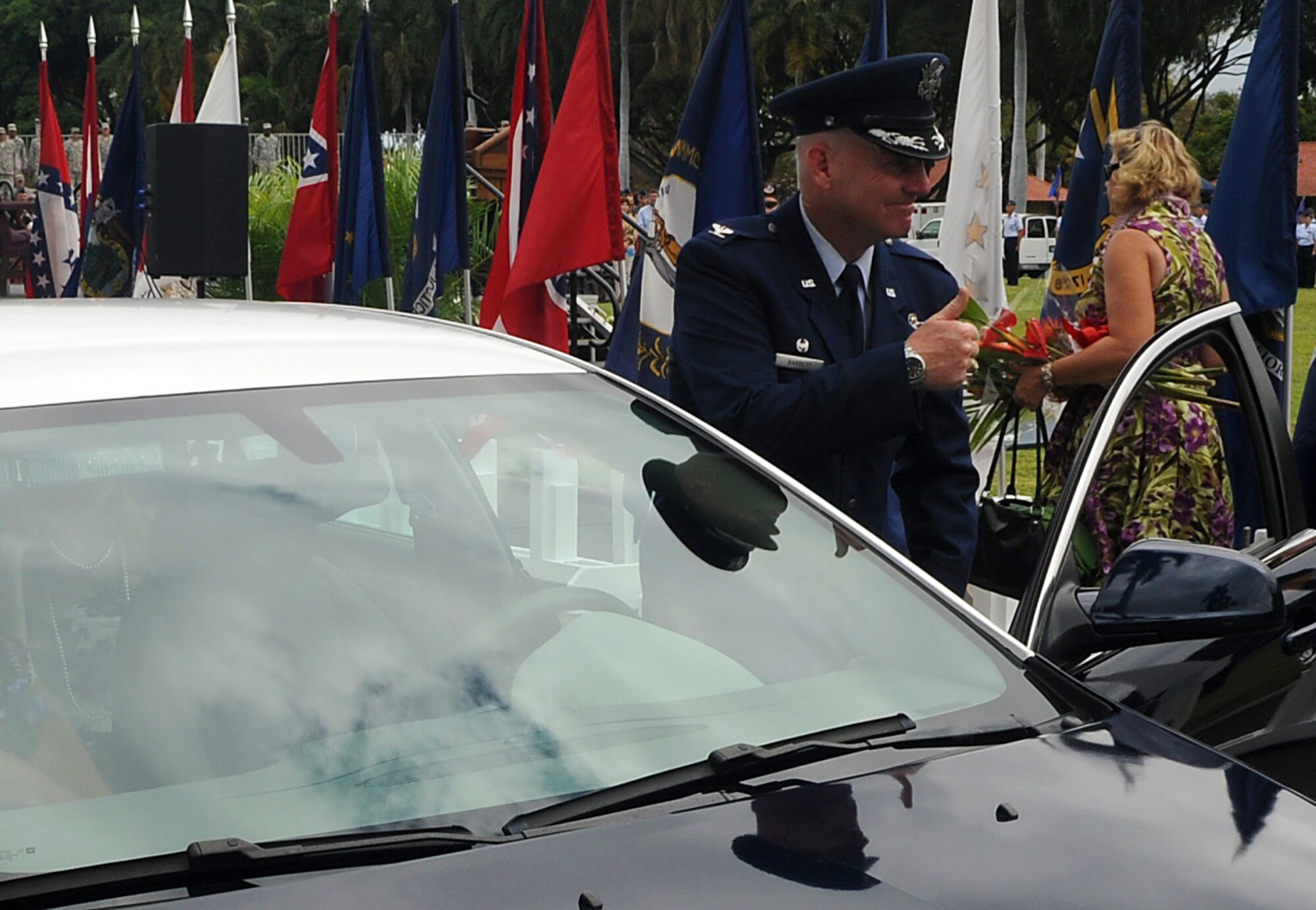 JOINT BASE PEARL HARBOR HICKAM, Hawaii -- Col. Sam Barrett, 15th Wing commander, gives thumbs up to his family after he assumed command of the 15th Wing during a change of command ceremony May 18. The change of command also included a re-designation from the 15th Airlift Wing to the 15th Wing. The re-designation reflects the mission change of the 15th Wing that will activate an active duty F-22 squadron and KC-135 squadron this summer. (U.S. Air Force photo/Staff Sgt. Mike Meares)