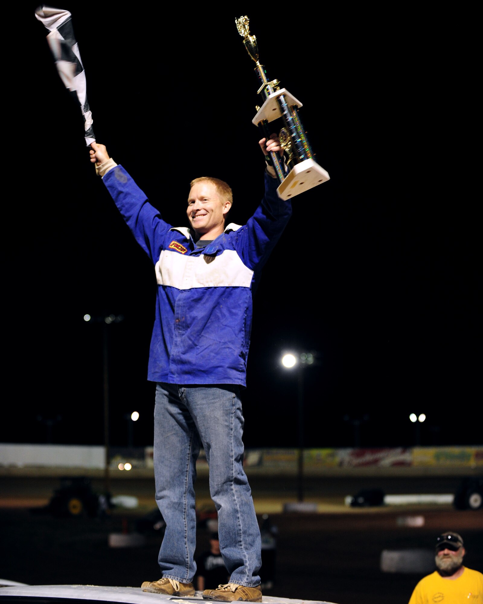 Maj. Jason Jensen, a pilot from the 357th Fighter Squadron, celebrates his second consecutive win in the USAF Hornet race at the USA Raceway track May 15. This year marked the second annual USA Raceway Military Appreciation night, honoring the men and women of the armed forces. (U.S. Air Force photo/Airman Jerilyn Quintanilla)