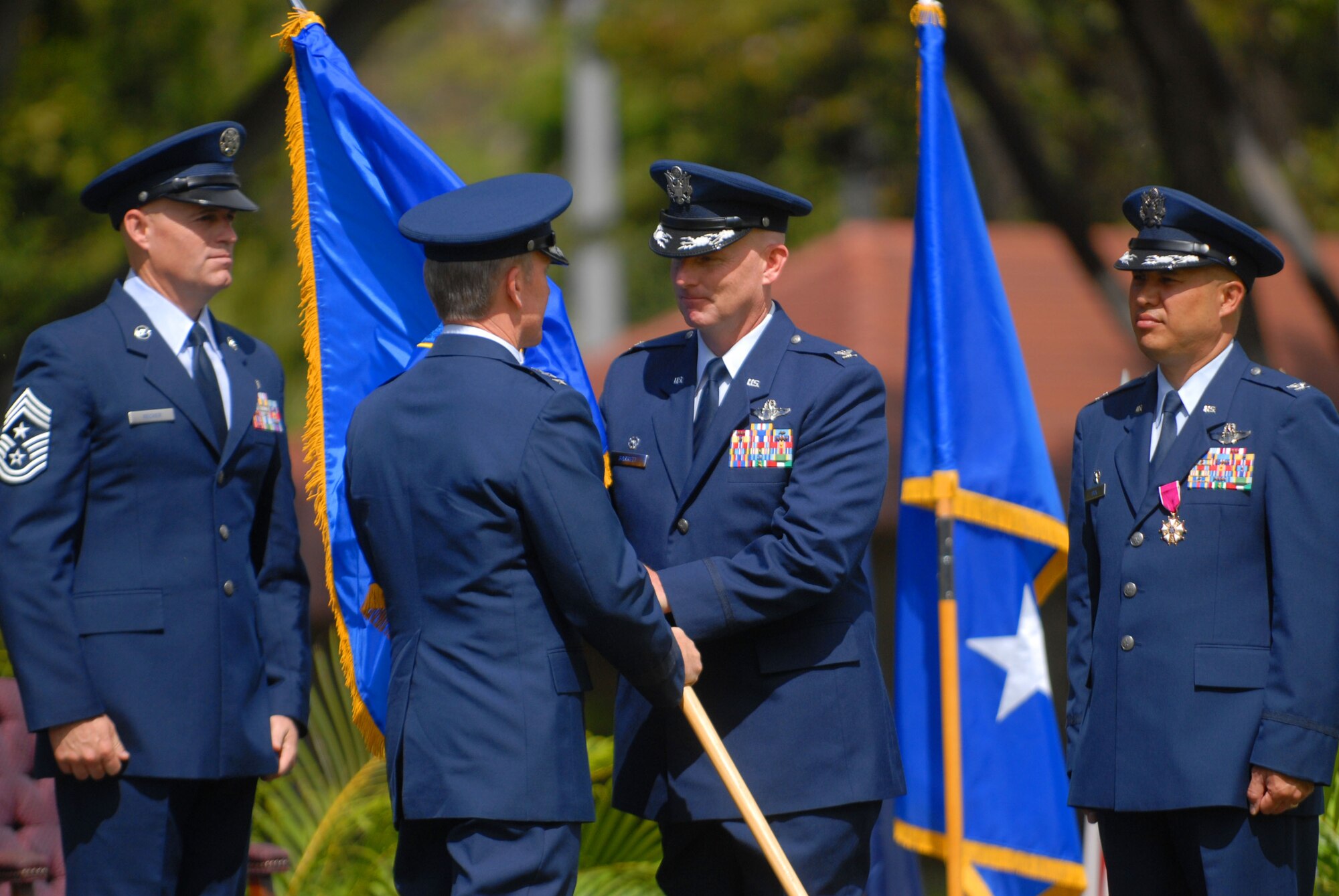 JOINT BASE PEARL HARBOR HICKAM, Hawaii - Col. Sam Barrett assumes command of the 15th Wing during the 15th Wing change of command here, May 18. The change of command also included a re-designation from the 15th Airlift Wing to the 15th Wing and remains assigned to the 13th Air Force. The re-designation reflects the mission change of the 15th Wing that will activate an active duty F-22 squadron and KC-135 squadron this summer. (U.S. Air Force photo/Senior Airman Gustavo Gonzalez) 