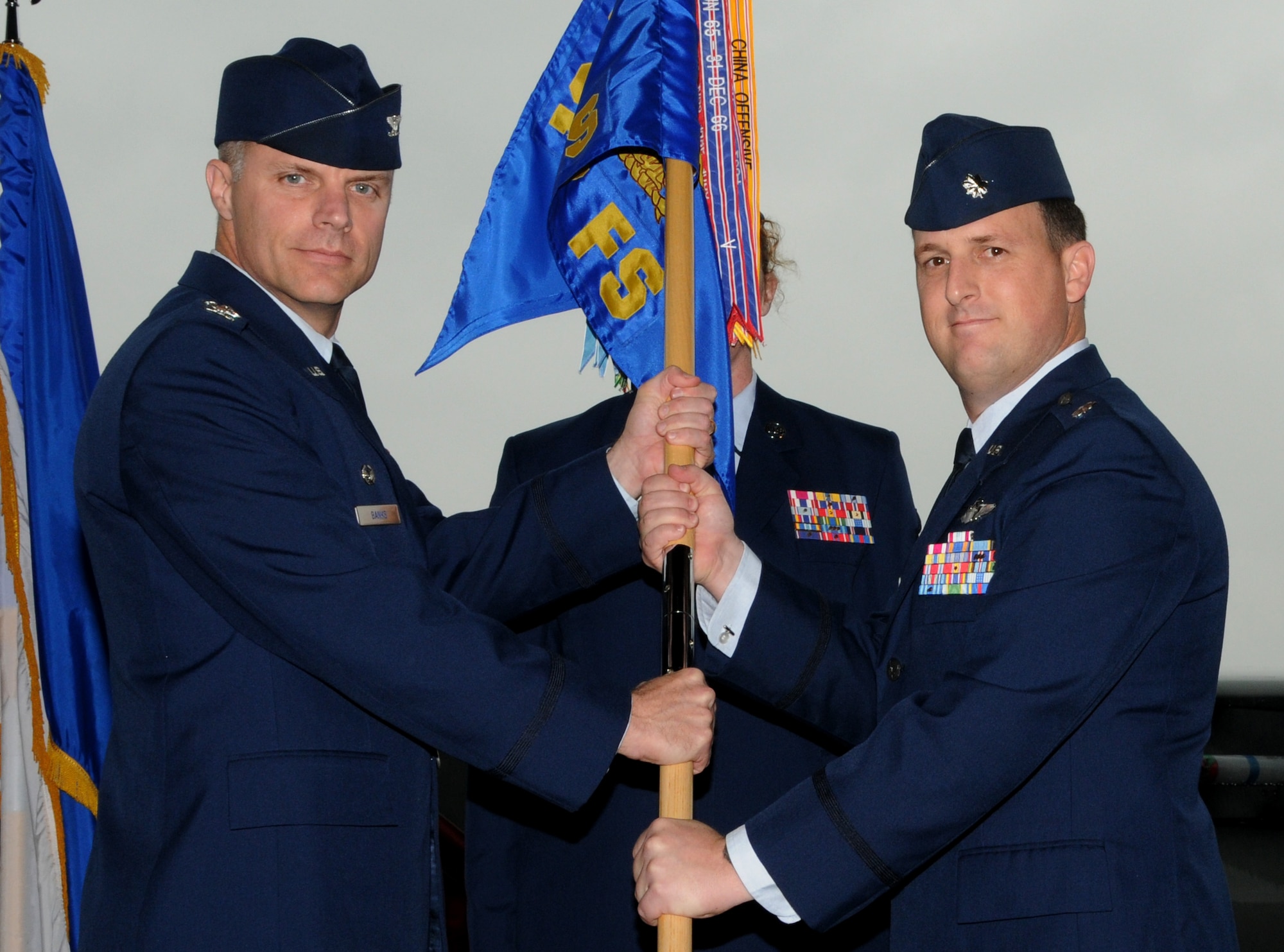 Lt. Col. Robert Cioppa accepts the 67th Fighter Squadron flag from Col. Ronald Banks, 18th Operations Group commander, during a change of command ceremony May 14, 2010.  (U.S. Air Force photo/Airman 1st Class Jarvie Wallace)