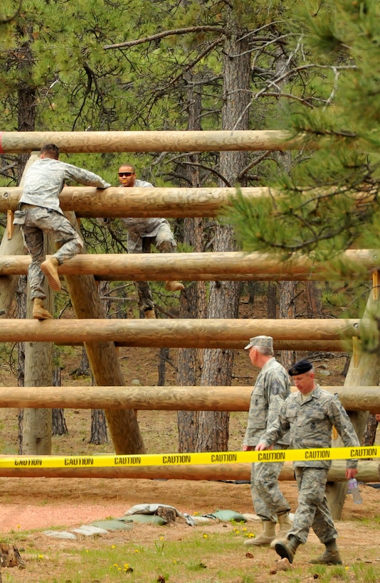 Tech. Sgt. Leslee Williams (right) climbs up one of the Assault Course obstacles as Staff Sgt. Alexr Andriyanov (left) descends on the other side during a practice run on the Assault Course at the U.S. Air Force Academy, Colo., May 18, 2010. Both are Guardian Challenge 2010 competitors from the Space and Missile Systems Center's 61st Security Forces Squadron at Los Angeles Air Force Base. (Photo by Lou Hernandez)