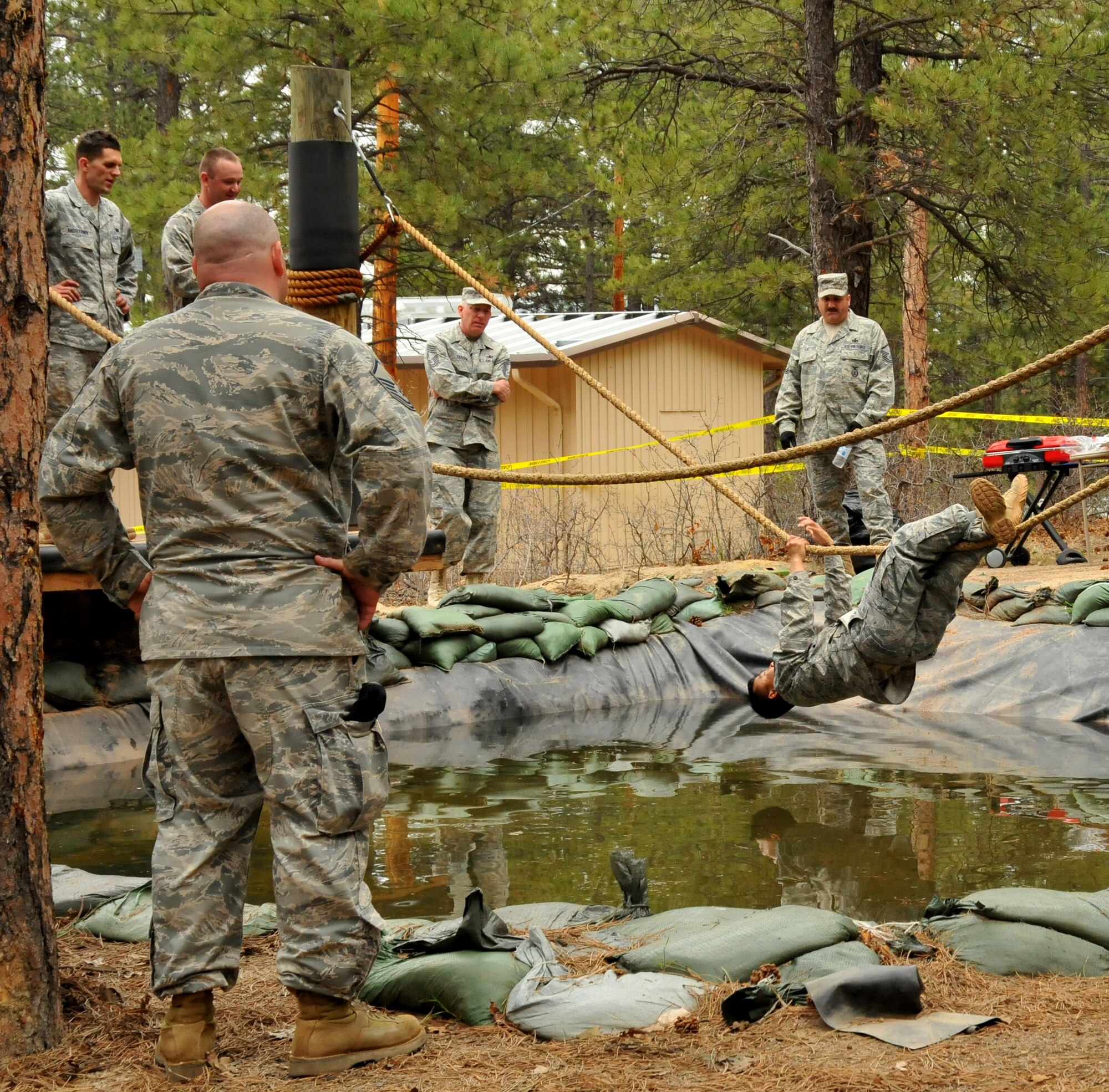 Tech. Sgt. Rochanapan Silpe goes hand over hand on the rope while hanging over water at the Assault Course during a practice run on the Assault Course at the U.S. Air Force Academy, Colo., May 18, 2010. Sergeant Silpe is a Guardian Challenge 2010 competitor from the Space and Missile Systems Center's 61st Security Forces Squadron at Los Angeles Air Force Base. (Photo by Lou Hernandez)