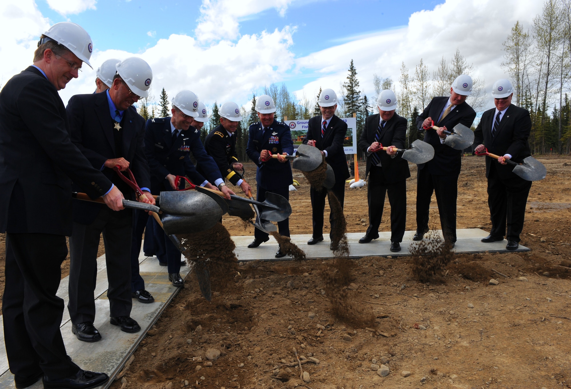 ELMENDORF AIR FORCE BASE, Alaska -- Civic leaders, Veterans Affairs personnel and military leaders turnover the first shovels full of dirt during the Fisher House of Alaska groundbreaking ceremony May 15. The Fisher House will be constructed as a two-story home comprising more than 16,000 square feet of living space and will feature 21 individual family living suites, each with a private bath. (Air Force photo by Senior Airman Cynthia Spalding)