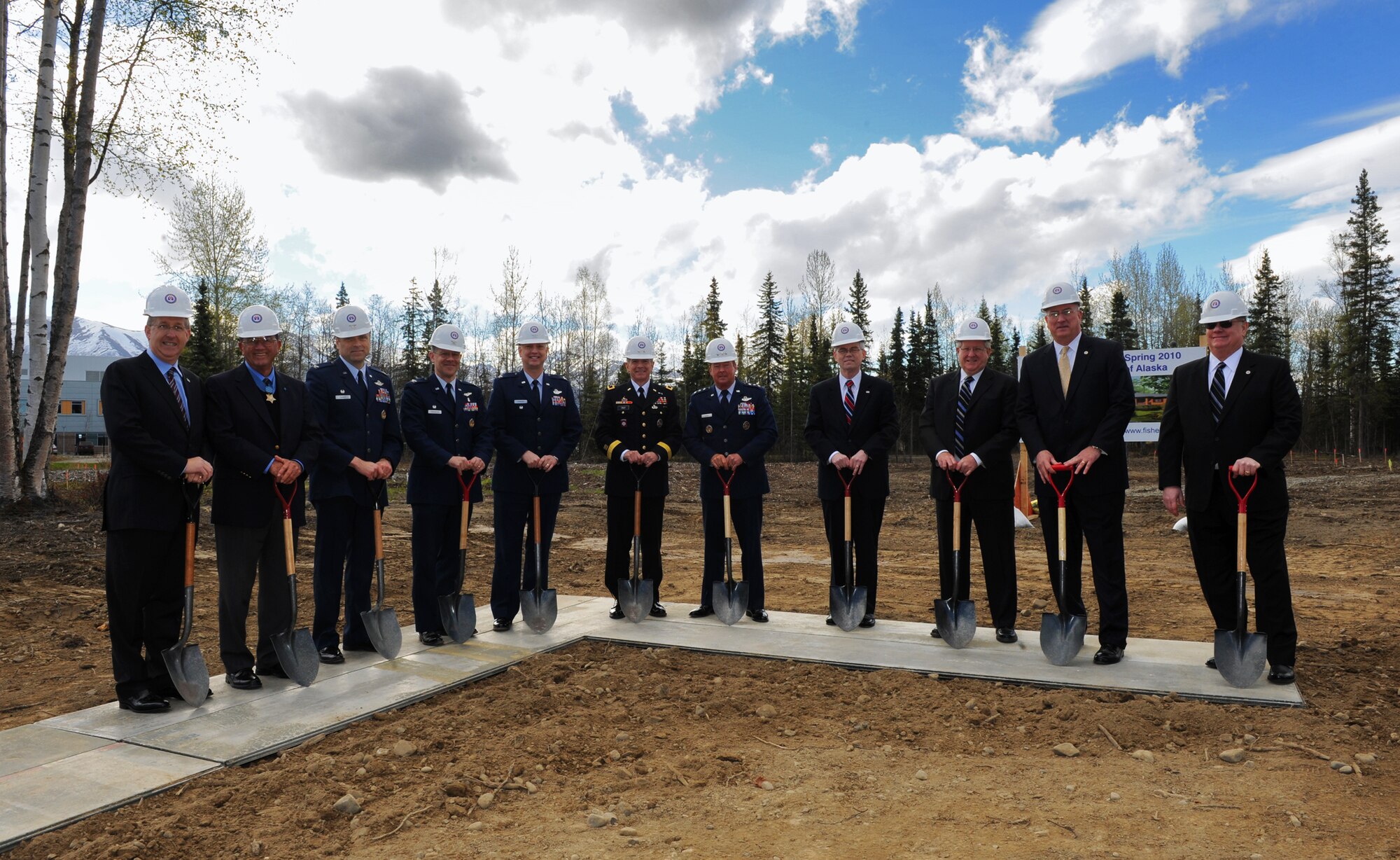 ELMENDORF AIR FORCE BASE, Alaska -- Civic leaders, Veterans Affairs personnel and military leaders gathered just before digging into the dirt during the Fisher House of Alaska groundbreaking ceremony May 15. The Fisher House will be constructed as a two-story home comprising more than 16,000 square feet of living space and will feature 21 individual family living suites, each with a private bath. (Air Force photo by Senior Airman Cynthia Spalding)