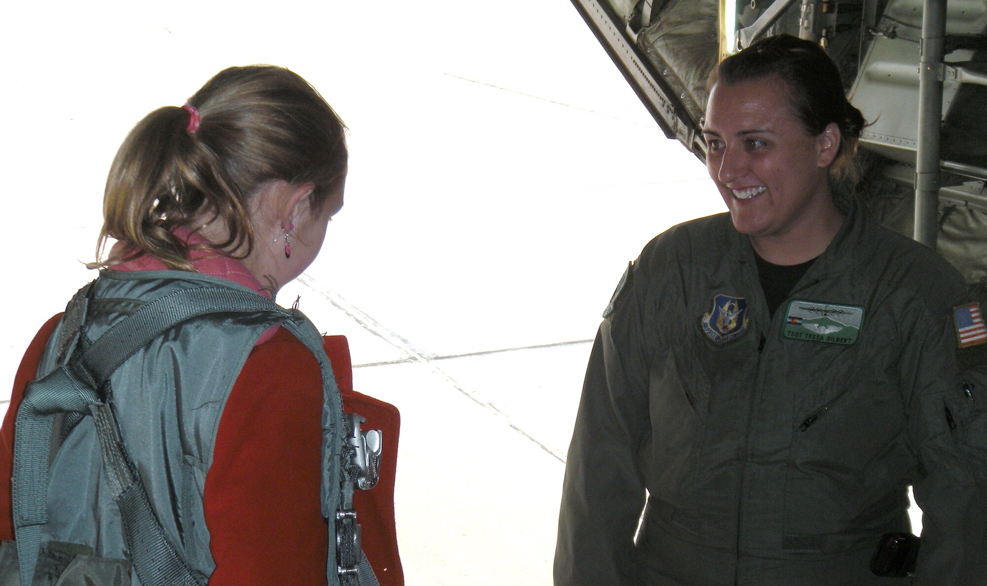 Tech. Sgt. Tessa Gilbert, an Air Force Reserve C-130 loadmaster assigned to the 731st Airlift Squadron, ensures a student's flight harness is properly secured May 18 at Peterson Air Force Base, Colo. The student was one of 11 from the Colorado Springs School that visited the 302nd Airlift Wing where they learned about aeronautics, the C-130 Hercules and the aerial firefighting mission of the wing. The students' visit was part of an eight-day learning excursion on the subject of aeronautics. The 302nd Airlift Wing is an Air Force Reserve Command unit based in southern Colorado. (U.S. Air Force photo/Staff Sgt. Stephen J. Collier)