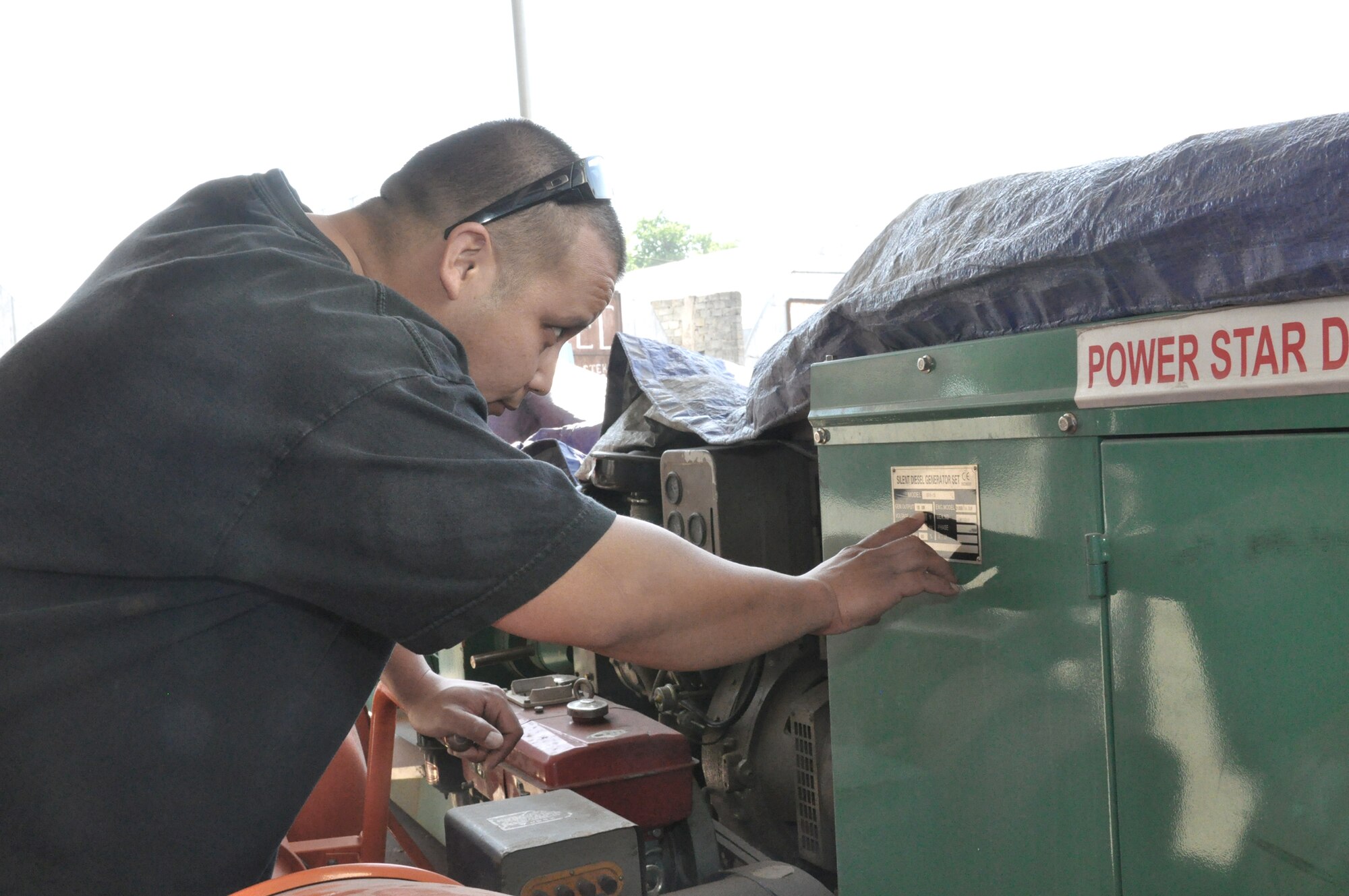 Tech. Sgt. Joseph Naputi checks out a generator May 13, 2010, in a local market prior to purchase.  Sergeant Naputi is from the 376th Expeditionary Civil Engineer Squadron at the Transit Center at Manas, Kyrgyzstan.  (U.S. Air Force phot/Staff Sgt. Carolyn Viss)