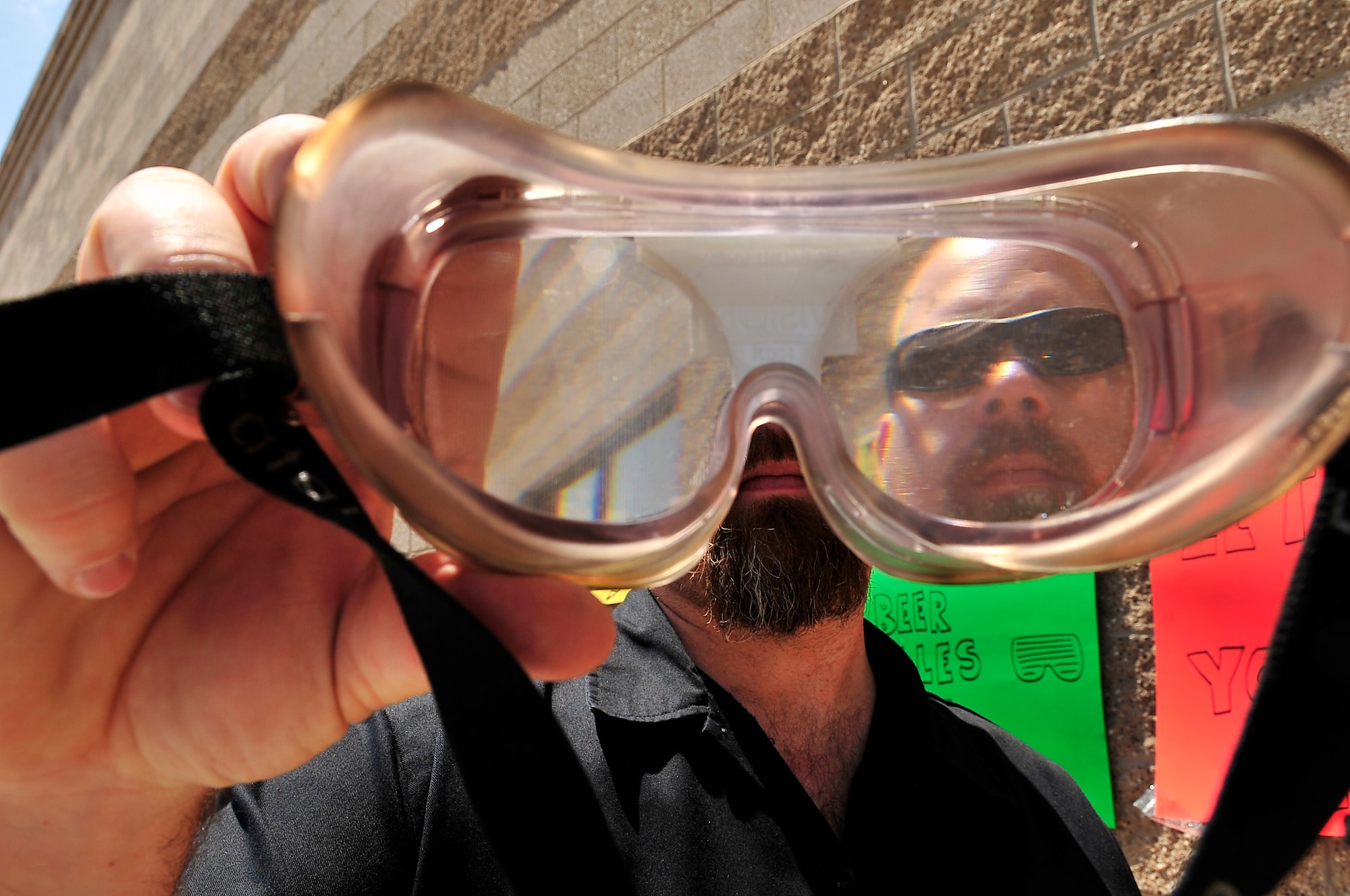 BUCKLEY AIR FORCE BASE, Colo. --  James Flammia, 460th Security Forces Squadron, holds up a pair of "fatal vision" goggles during National Police Week here May 14. Fatal vision goggles distort the view of the wearer to simulate impaired vision caused by alcohol or drugs. (U.S. Air Force photo by Staff Sgt. Kathrine McDowell)