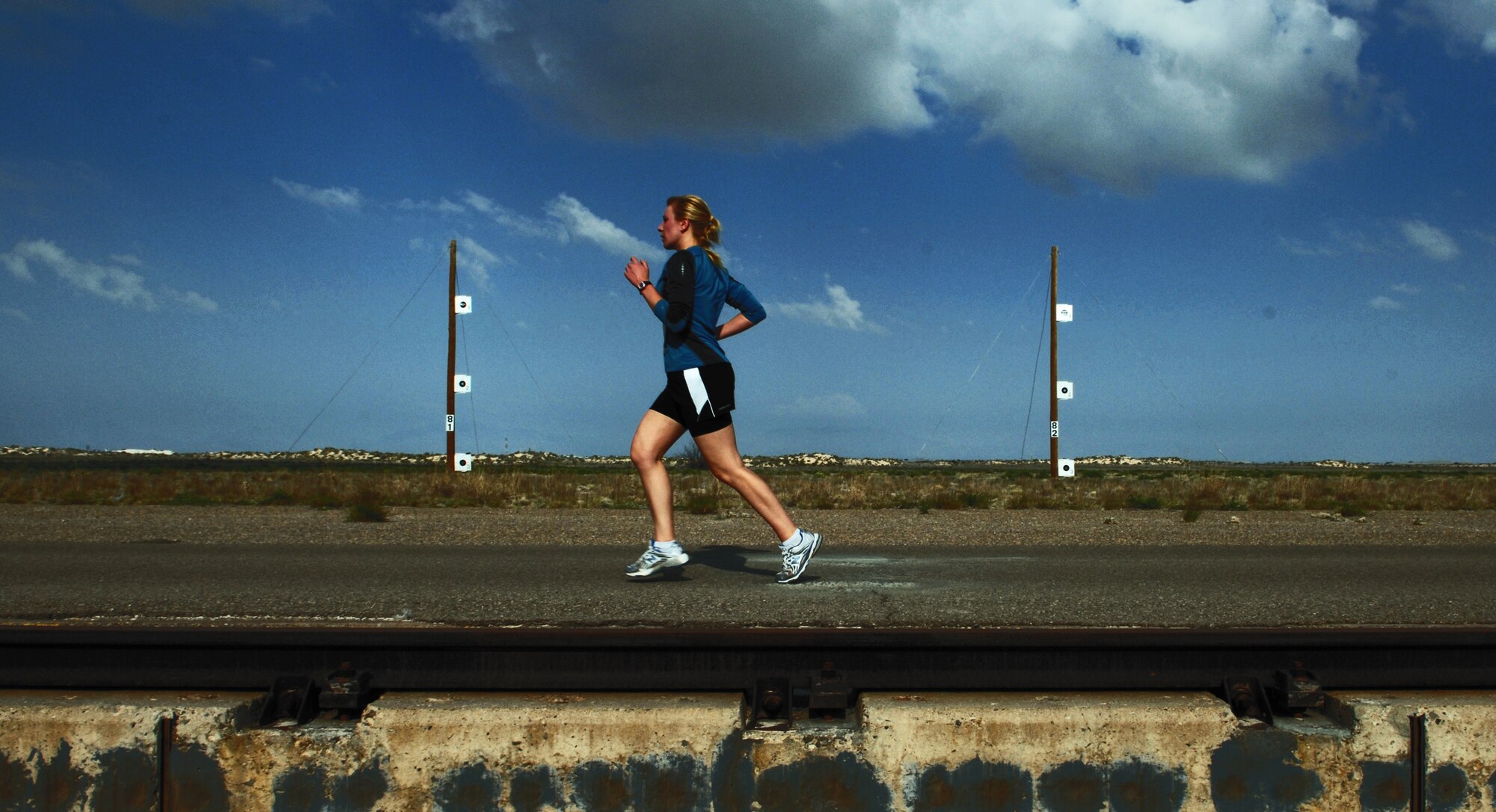 HOLLOMAN AIR FORCE BASE, N.M. -- 2nd Lt. Katelyn Riley, 49th Force Support Squadron, runs next to the high speed test track during the Mach 10k Annual Fun Run May 14, 2010. The fun run, hosted by the 846th Test Squadron, is held annually to promote physical fitness, morale and camaraderie for military and civilian personnel. (U.S. Air Force photo by Airman 1st Class Joshua Turner / Released)
