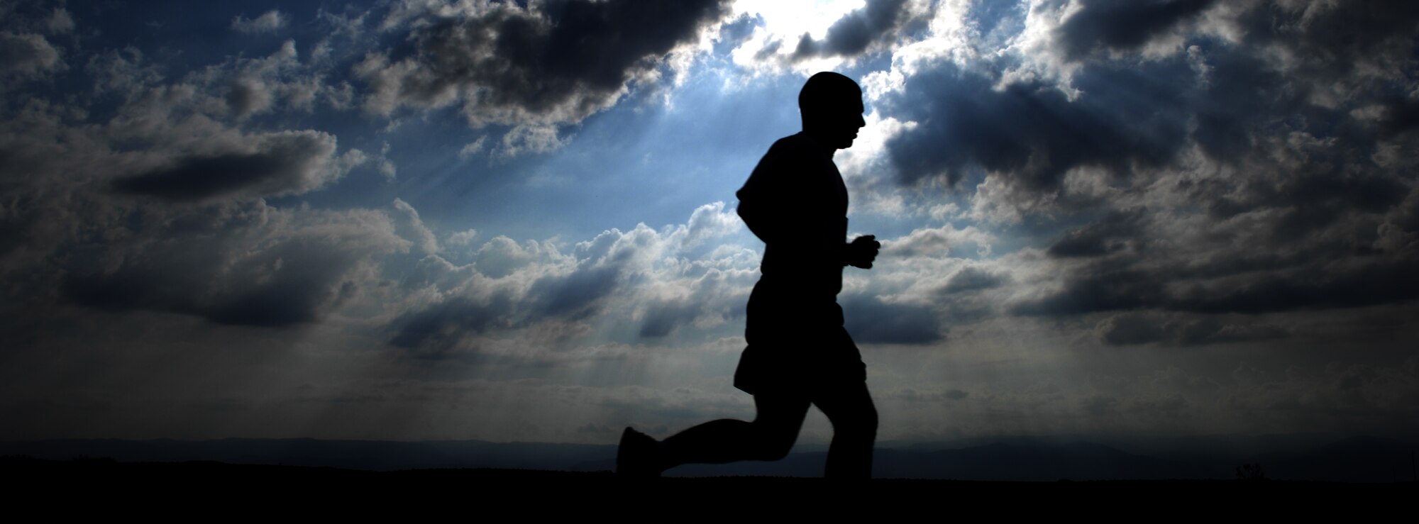 HOLLOMAN AIR FORCE BASE, N.M.--- Tech. Sgt Ryan Perry, 49th Material Maintenance Support Squadron, runs next to the high speed test track during the Mach 10k Annual Fun Run May 14, 2010. The fun run, hosted by the 846th Test Squadron, is held annually to promote physical fitness, morale and camaraderie for military and civilian personnel. (U.S. Air Force photo by Airman 1st Class Joshua Turner / Released)