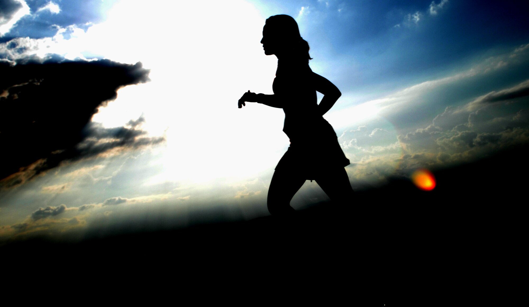 HOLLOMAN AIR FORCE BASE, N.M. -- Elizabeth Hingley, wife of Maj. Dan Hingley, 49th Fighter Wing, runs next to the high speed test track during the Mach 10k Annual Fun Run May 14, 2010. The fun run, hosted by the 846th Test Squadron, is held annually to promote physical fitness, morale and camaraderie for military and civilian personnel. (U.S. Air Force photo by Airman 1st Class Joshua Turner / Released)
