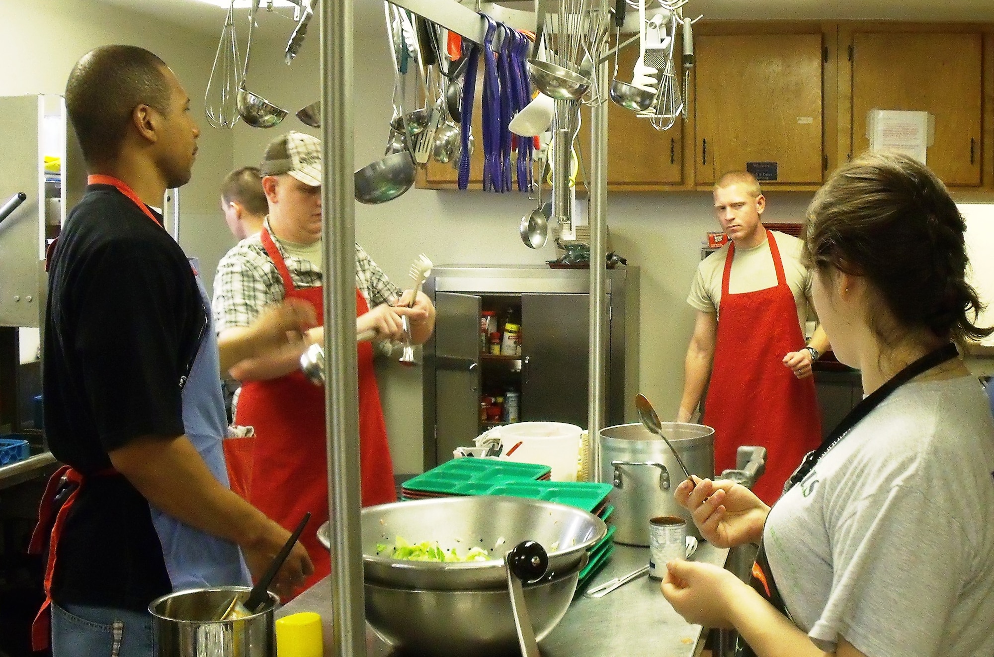 Airmen from the First Term Airmen Center help prepare meals at the Soup Kitchen to hand out to needy, low income and homeless people in the community. The kitchen provides an average of 115 meals a day with the help of volunteers. (U.S. Air Force photo/Tech. Sgt. Shaila Lane)