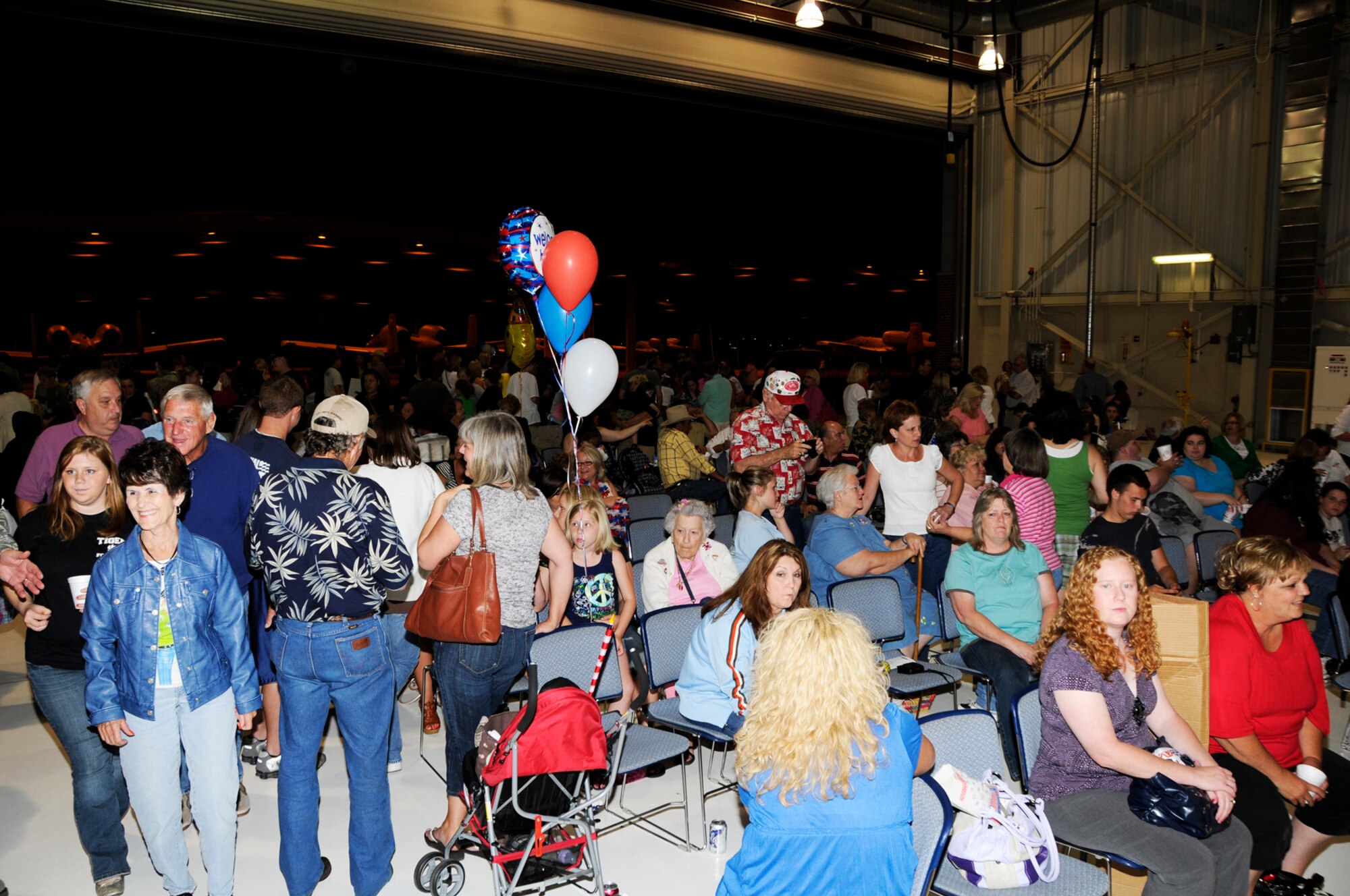 Family members of deployed 188th Fighter Wing Airmen await the arrival of a DC-10 carrying more than 200 Guardsmen, who returned from a deployment to Kandahar Airfield in Afghanistan May 17. A homecoming assembly was held at the 188th's Consolidated Maintenance Facility. More than 1,000 people flocked to the 188th to show their support and welcome home their deployed loved ones. (U.S. Air Force photo by Tech Sgt. Stephen Hornsey/188th Fighter Wing Public Affairs)