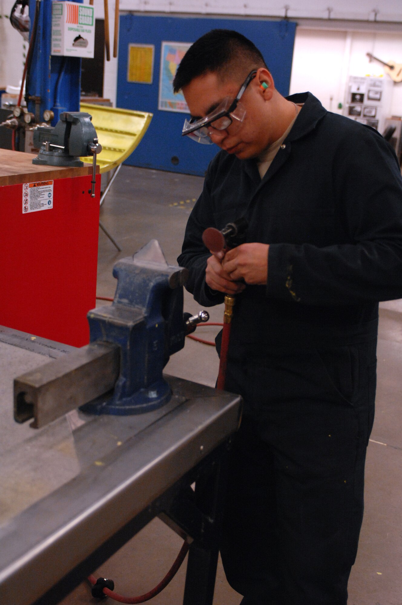 MINOT AIR FORCE BASE, N.D. -- Airman 1st Class Fernando Montenegro, 5th Maintenance Squadron structural maintainer, fabricates a bracket for a cowling wrap here May 13. The 5th MXS supports the 5th Bomb Wing by providing equipment maintenance on its B-52H Stratofortresses. (U.S. Air Force photo by Airman 1st Class Aaron-Forrest Wainwright)