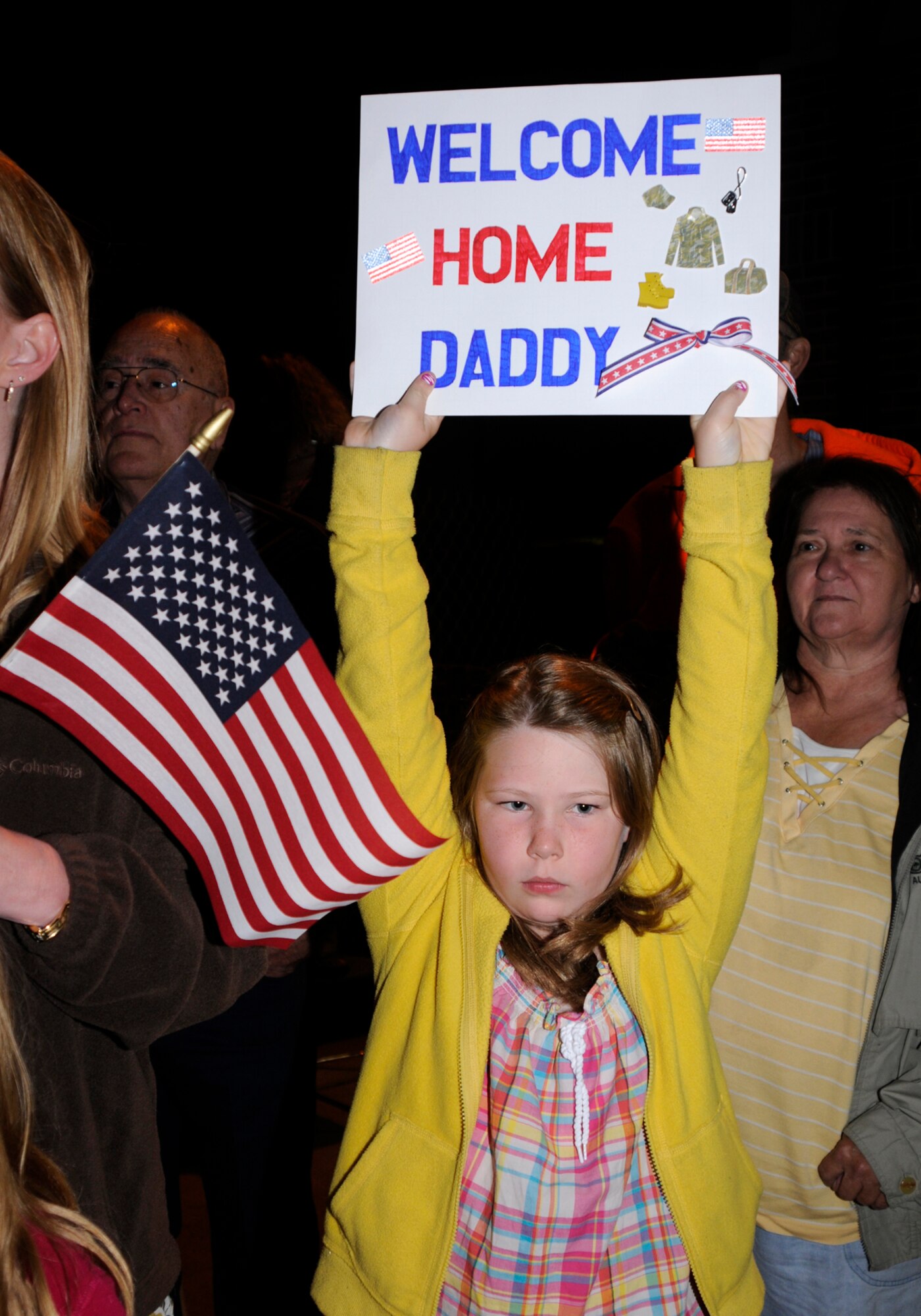 A family member of a deployed 188th Fighter Wing Airman displays a sign during a homecoming gathering at the Fort Smith (Ark.) Air National Guard unit to welcome back the Guardsmen, who were deployed to Kandahar Airfield in Afghanistan. More than 200 Airmen returned May 17. (U.S. Air Force photo by Capt. Heath Allen/Arkansas National Guard Public Affairs)