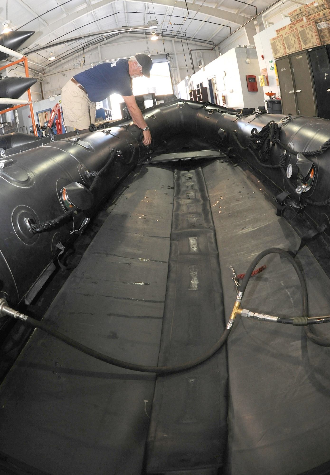 Pat Sinon cleans an F-470 Zodiac inflatable boat after a water training exercise May 12, 2010, at Moody Air Force Base, Ga. The Zodiac inflatable boat is used for water operations by the 38th RQS. Mr. Sinon is a 38th Rescue Squadron logistics flight boat master. 
