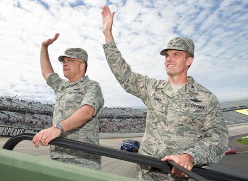 Col. Randal L. Bright, 512th Airlift Wing commander, (left) and Col. Dwight C. Sones, 436th Airlift Wing vice commander, wave to NASCAR fans while taking the parade lap prior to the race beginning at Dover International Speedway, Dover, Del., May 16.  Airmen from Dover Air Force Base came out to support the event -- to include the 436th AW chaplain and Team Dover firefighters. The 512th AW is the only Air Force Reserve Command unit in Delaware with around 1,800 members from more than 40 states.  (U.S. Air Force photo/Roland Balik)