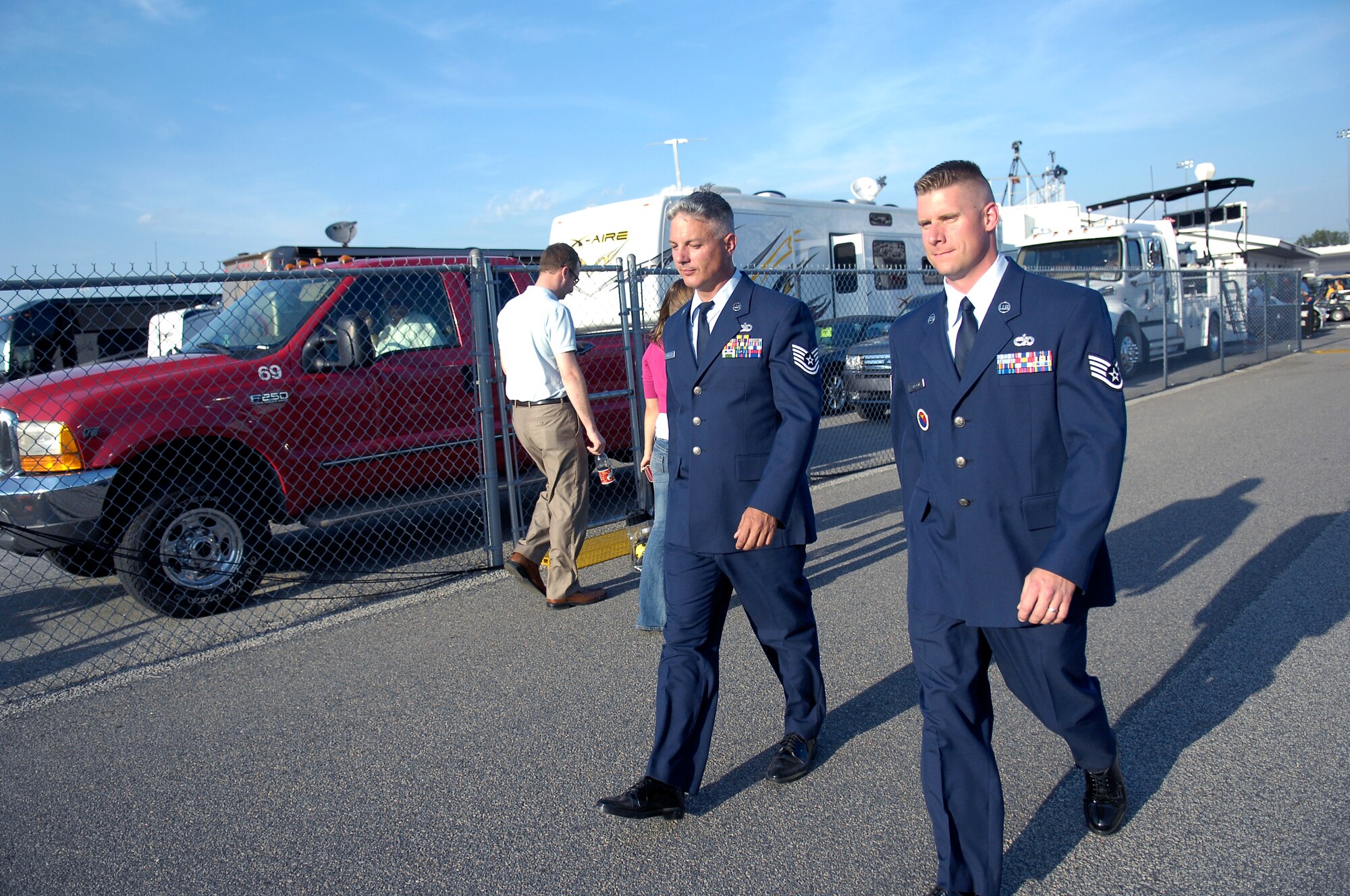 Tech. Sgt. John Norman, 3rd Aerial Port Squadron, and Staff Sgt. Kenneth Shelton, 43rd Force Support Squadron, make their way to the stage to sing the National Anthem at the SHOWTIME Southern 500 NASCAR race at Darlington Raceway in Darlington S.C. on May 8. (U.S. Air Force photo/2nd Lt. Cammie Quinn)