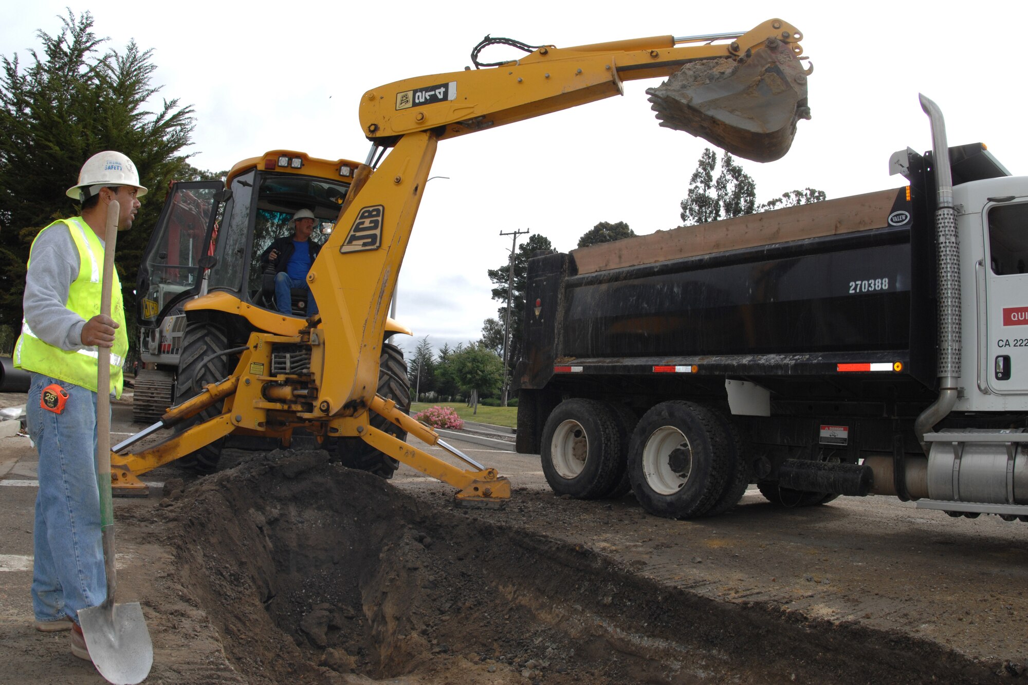 VANDENBERG AIR FORCE BASE, Calif. – Leobardo Herrera, of the Environmental Assessment and Remediation Construction Company, observes Shannon Stuart, of the EAR Construction Company, as he dumps dirt in the back of a truck during  construction at the Utah Gate here Tuesday, May 18, 2010. The Environmental Assessment and Remediation Construction Company is replacing 3,600 feet of water pipelines with welded material to eliminate possible leakages in the furture. (U.S. Air 
Force photo/Senior Airman Christopher Hubenthal)