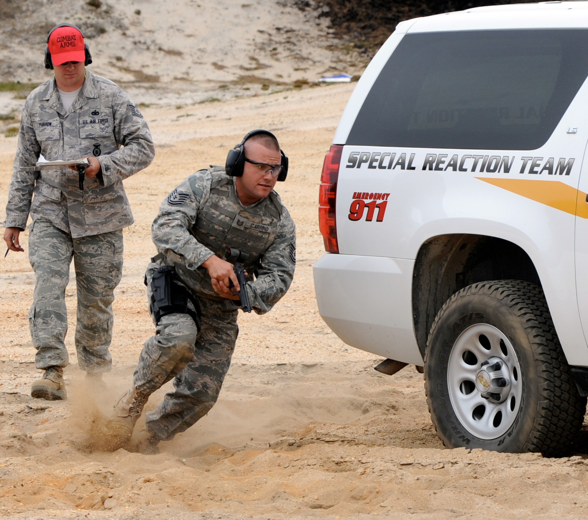 Tech.Sgt.Thomas Carpino, 421st Combat Training Squadron noncommissioned officer in charge of standardization evaluations, runs through the tactical course as Tech. Sgt. Ricky Furrow, 87th Security Forces Squadron, judges during the May 11 Police Week tactical shooting competition. Police Week is an annual event held to honor law enforcement professionals who passed in the line of duty and to build camaraderie amongst different law enforcement agencies. (U.S. Air Force photo/Wayne Russell)