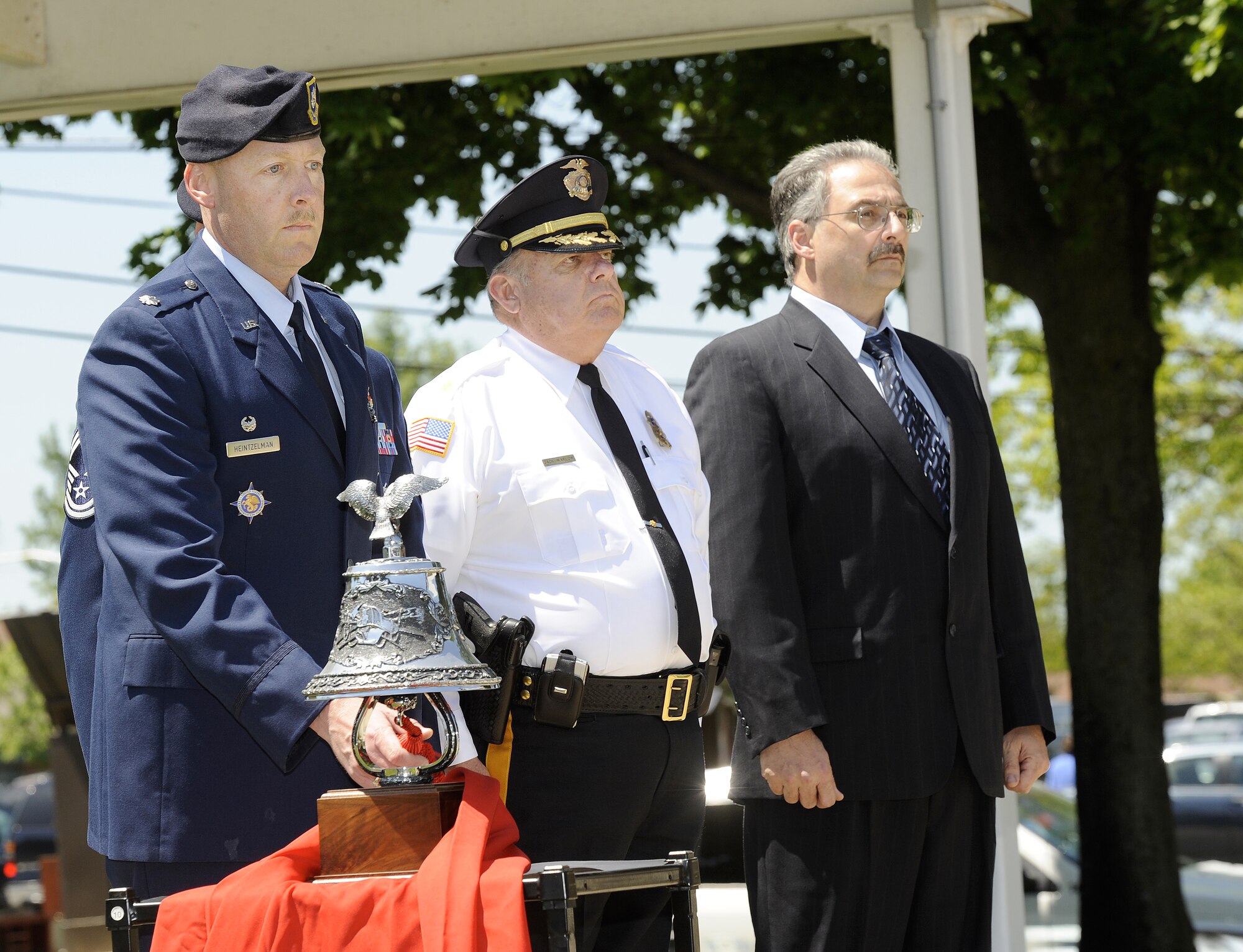 Lt. Col. Tim Heintzelman, 87th Security Forces Squadron commander, rings a bell in memory of fallen law enforcement officials at the Police Week opening ceremony May 10 on Sharpe Parade Field. He was accompanied by Maj. Jack Warlow and Edward Dressler, also members of the 87th SFS. National Police Week pays honor to those who lost their lives in the line of duty for the safety and protection of others. (U.S. Air Force photo/Carlos Cintron)
