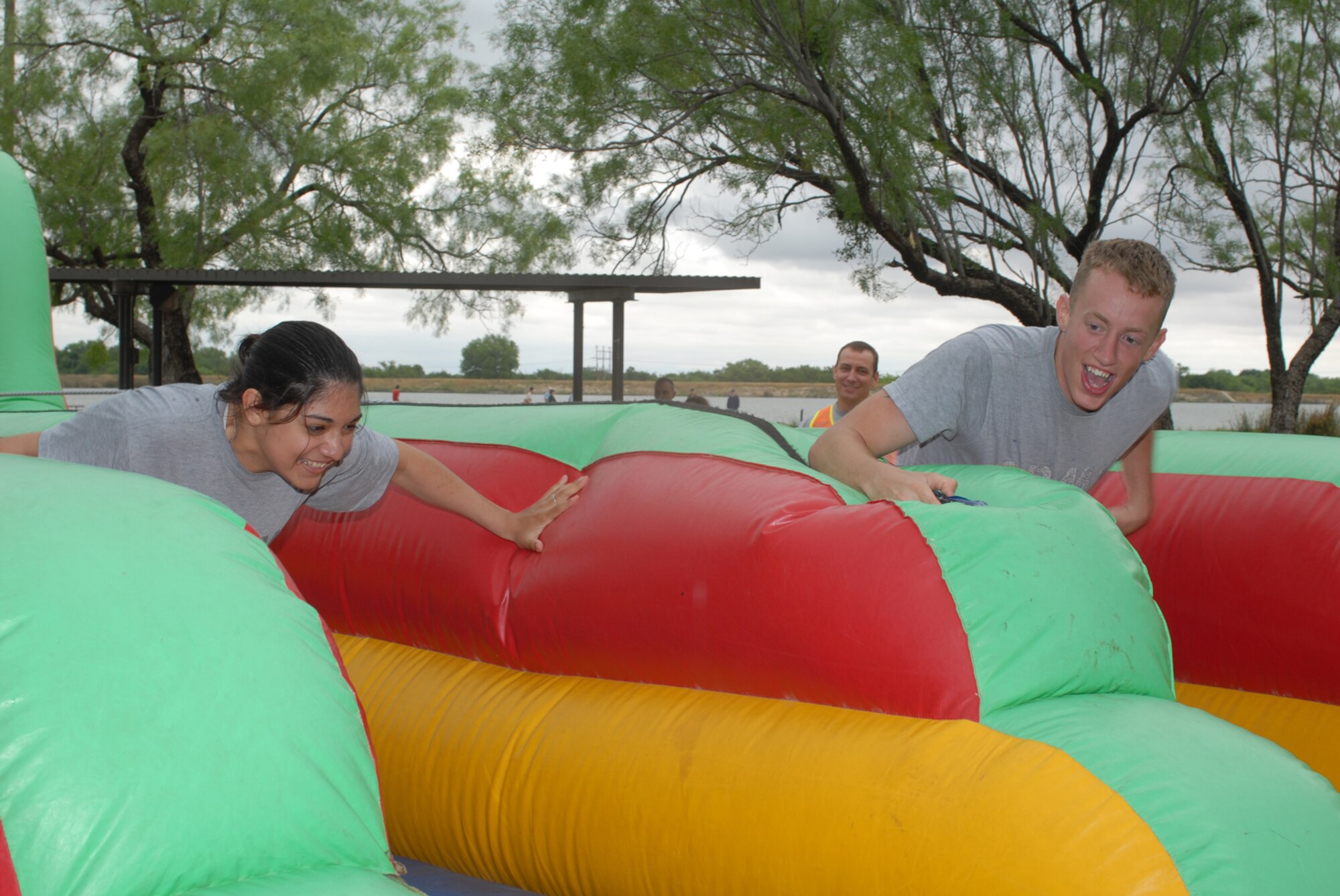 SAN ANGELO, Texas -- Army Spc. Melissa Cadwallader and Army Pvt. Collin Stein, 344th Military Intelligence Battalion students, attempt to place velcro markers at the farthest point they can on the bungee run during the 5th Annual Military Appreciation Day, May 15, 2010. The event, held at the Goodfellow Air Force Base Recreation Camp, was hosted by the San Angelo Chamber of Commerce. (U.S. Air Force photo/Staff Sgt. Laura R. McFarlane)
