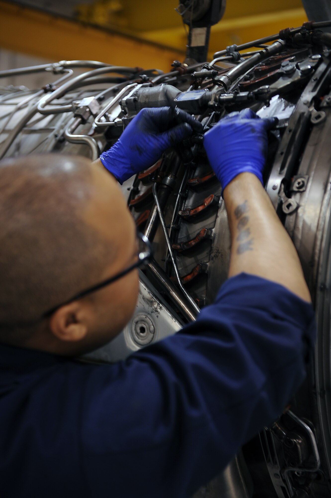 SEYMOUR JOHNSON AIR FORCE BASE, N.C. -- Staff Sgt. Ira Coe loosens bolts and screws on an inlet guide vane for removal May 13, 2010. An inlet guide vane provides rotation to the refrigerant vapor entering the compressor, improving engine efficiency. Sergeant Coe, 4th Component Maintenance Squadron aerospace propulsion craftsman, hails from Columbus, Ga. (U.S. Air Force photo/Senior Airman Ciara Wymbs) 
