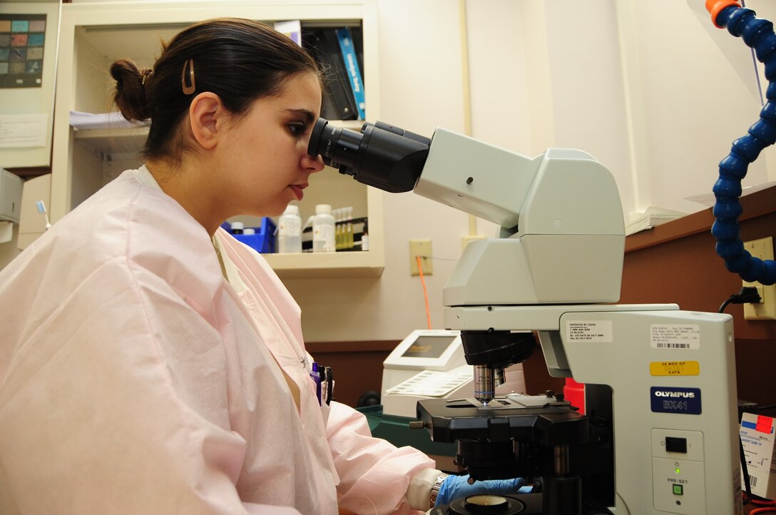 ELLSWORTH AIR FORCE BASE, S.D. -- Staff Sgt. Danielle Struss, 28th Medical Group lab technician, analyzes urine samples under a microscope, May 18.  Sergeant Struss made several checks for impurities in the urine, such as, minute amounts of sugar, which could indicate a patient has diabetes. (U.S. Air Force photo/Airman 1st Class Anthony Sanchelli)