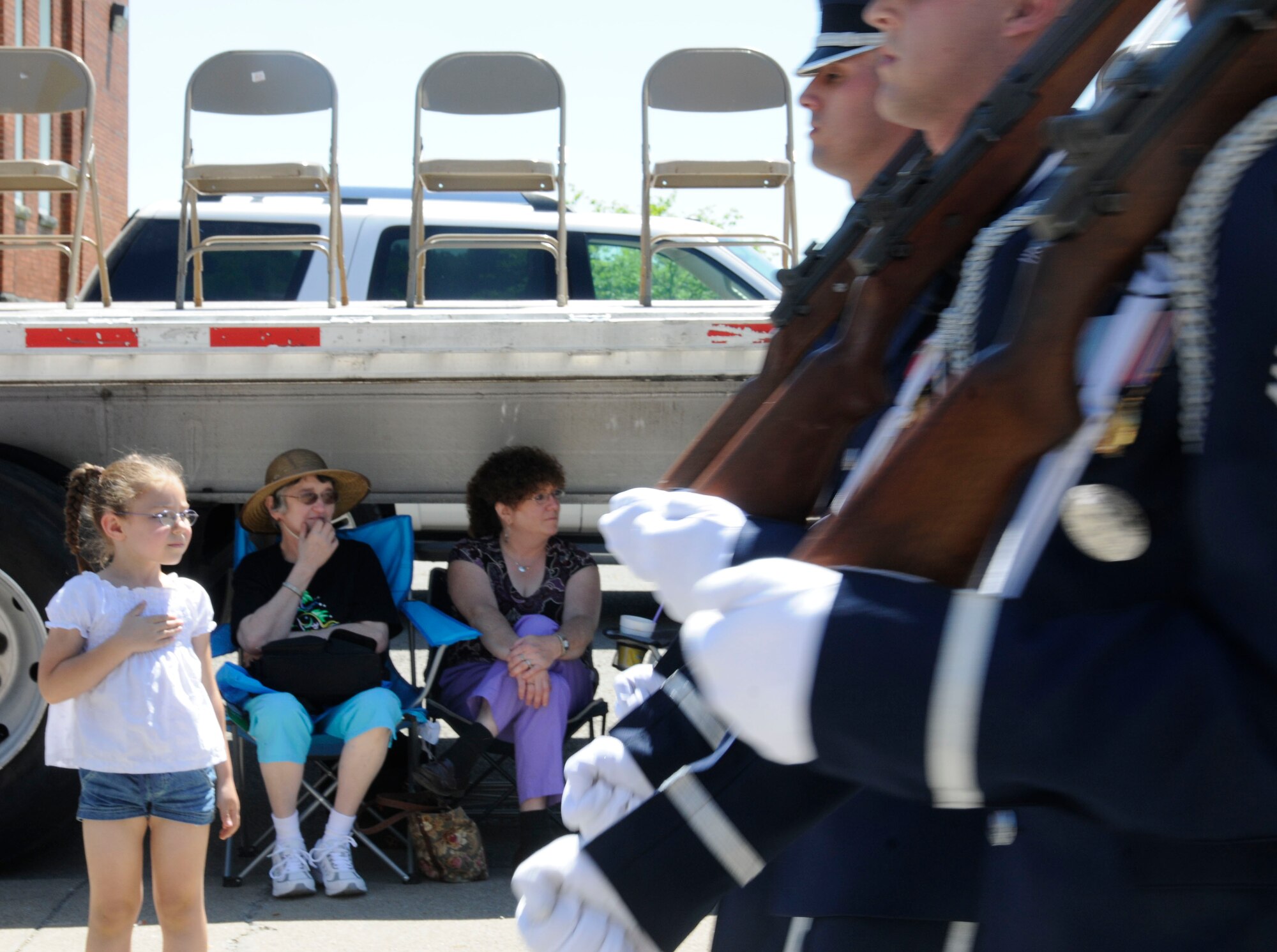 A child places her hand over her heart as the U.S. Air Force Honor Guard Parade Flight marches by at the Buckhannon, W.Va., Strawberry Festival Parade May15. The parade was the newly-created flight's first performance. (U.S. Air Force photo by Airman 1st Class Susan Moreno)