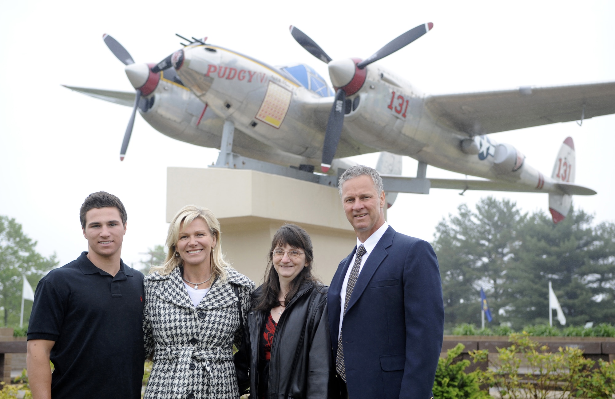 The Kish family poses in front of Pudgy, P-38 Lightning static display, before the Airman Leadership School building dedication ceremony here May 12. Pudgy has the name of Tech. Sgt. Frank Z. Kish painted on the left engine. Kish served as Maj. Thomas B. McGuire’s maintenance crew chief during World War II. (U.S. Air Force photo/Carlos Cintron) 