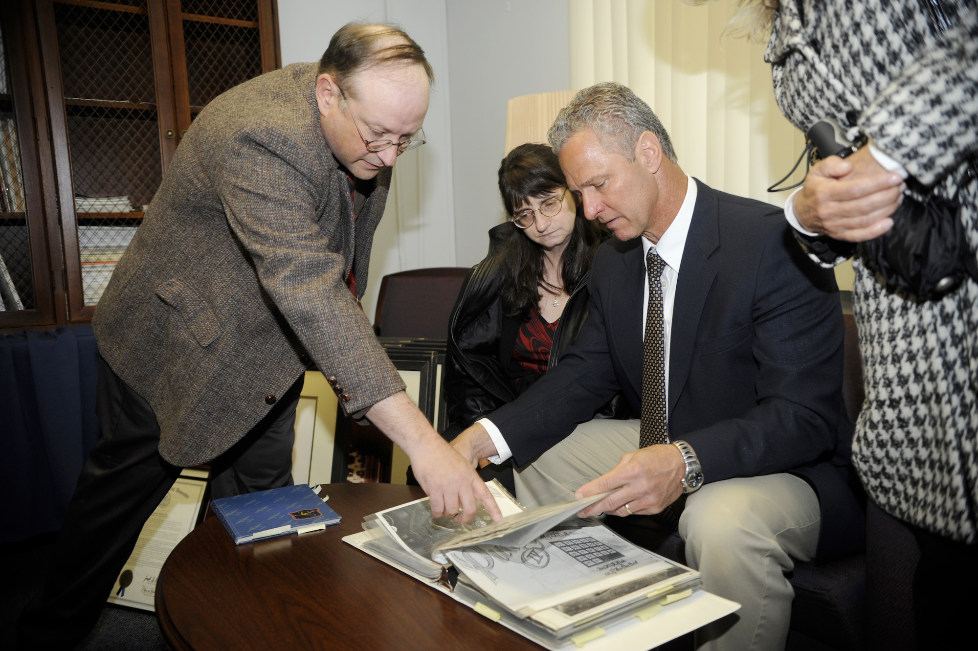 Gary Boyd, Air Force History and Museum programs director, shows Ed and Betsy Kish, son and daughter of Tech. Sgt. Frank Z. Kish, some original hand-written documents from their father during World War II. The Kish family toured the history museum at the NCO Academy at Joint Base McGuire-Dix-Lakehurst May 12. (U.S. Air Force photo/Carlos Cintron) 