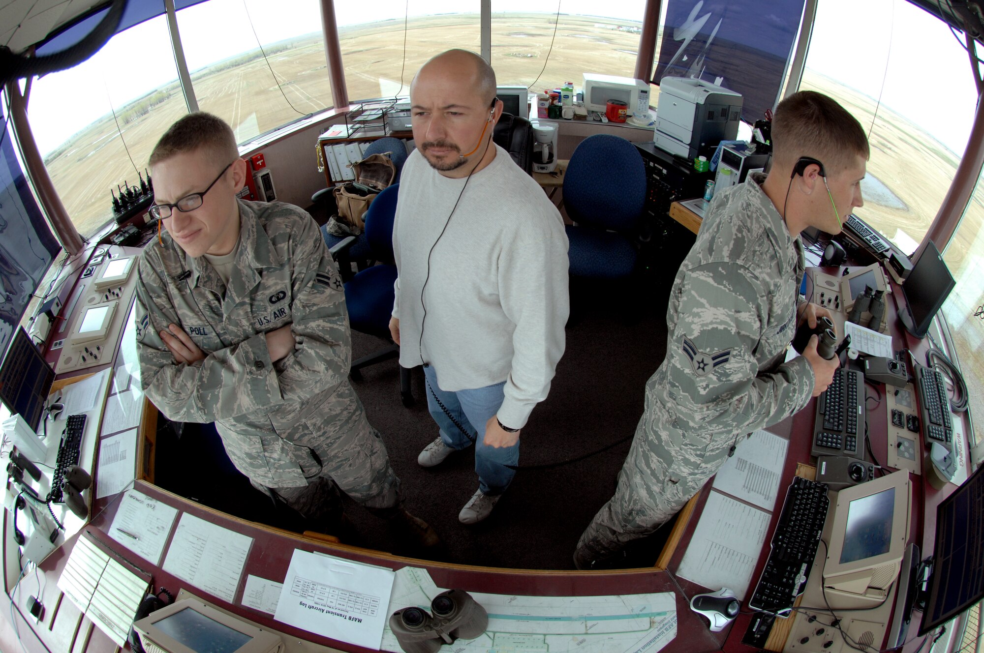 MINOT AIR FORCE BASE, N.D. --(left to right ) Airman 1st Class Mason Poll, air traffic control journeyman, Michael Porreca, ATC watch supervisor, and Airman 1st Class Thomas Jirkovsky, ATC apprentice, all from the 5th Operations Support Squadron, ensure clarity and safety of the flight line prior to a plane landing here May 12. Air traffic controllers operate air traffic systems to expedite and maintain a safe, orderly flow of air traffic as well as flight line activity. (U.S. Air Force photo by Senior Airman Jesse Lopez)