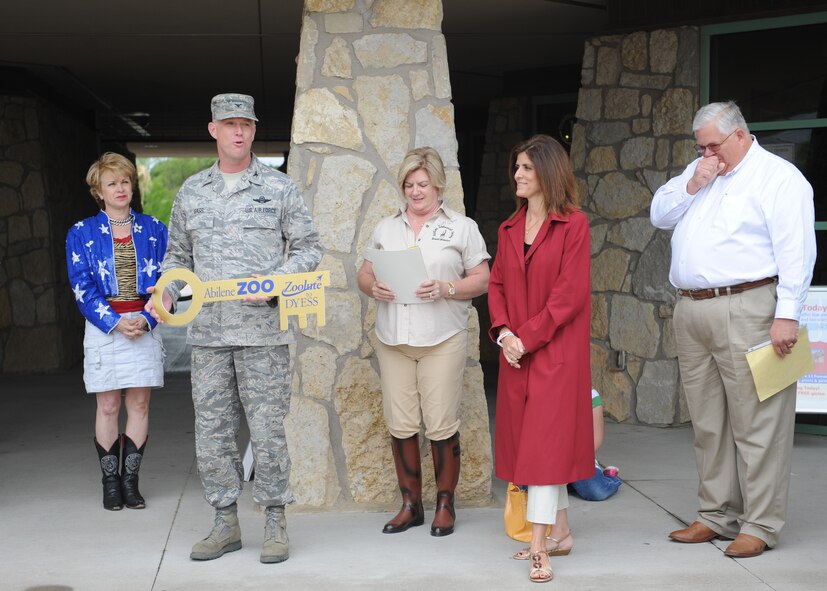 ABILENE, Texas—Members of The Abilene Zoological Society present Col. Robert Gass, 7th Bomb Wing commander, with a key and proclamation May 15 at the Abilene Zoo designating this date of each year “Zoolute to Dyess.” Zoolute is a day of appreciation dedicated to members of the armed forces extending to retirees and family. In honor of the day, they were treated with a free pass to the zoo, food, drinks and prizes. (U.S Air Force photo/ Airman 1st Class Shannon Hall)